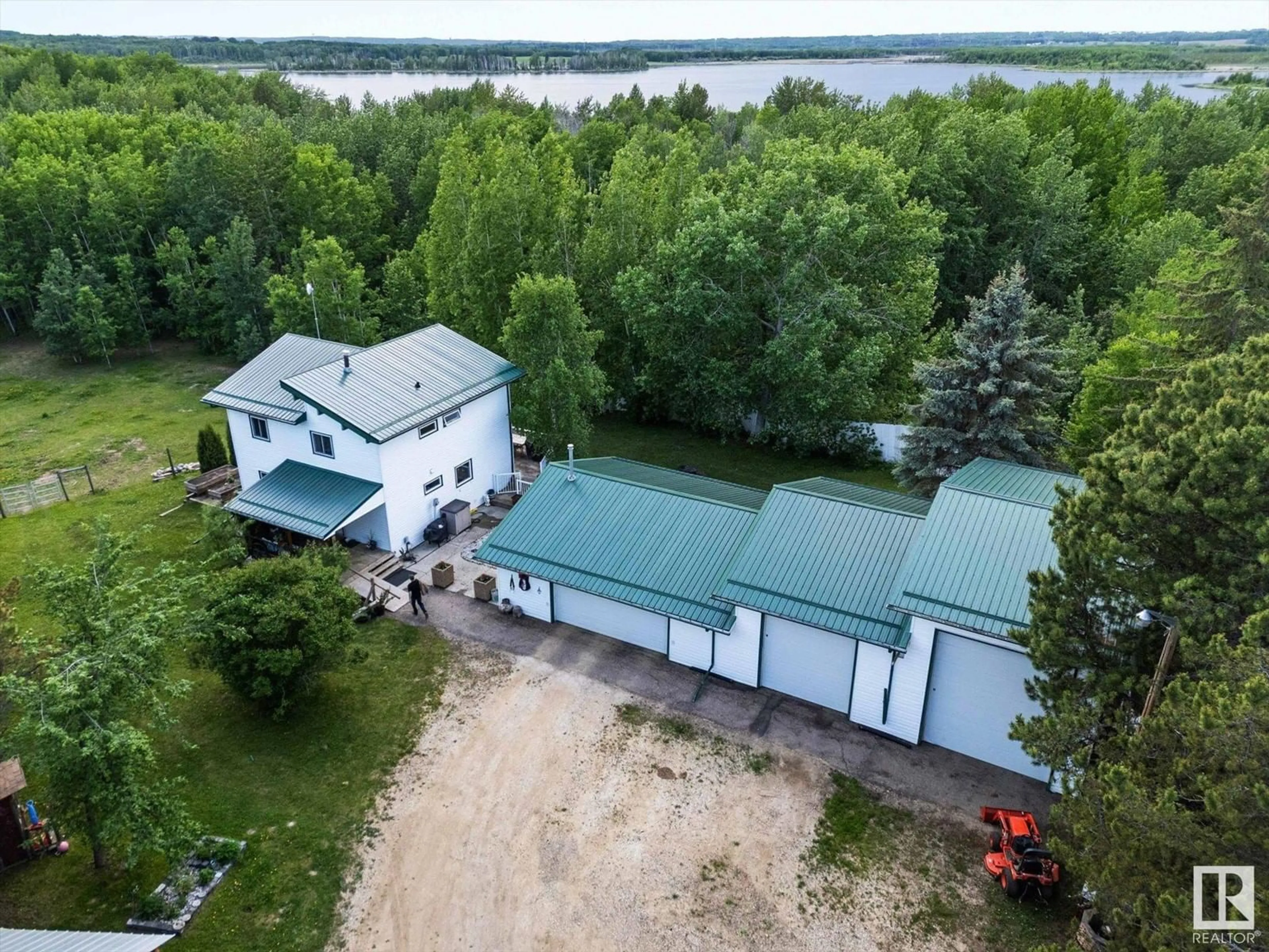 A pic from outside/outdoor area/front of a property/back of a property/a pic from drone, water/lake/river/ocean view for 52510 - 23 RGE ROAD 25, Rural Parkland County Alberta T0E0H0