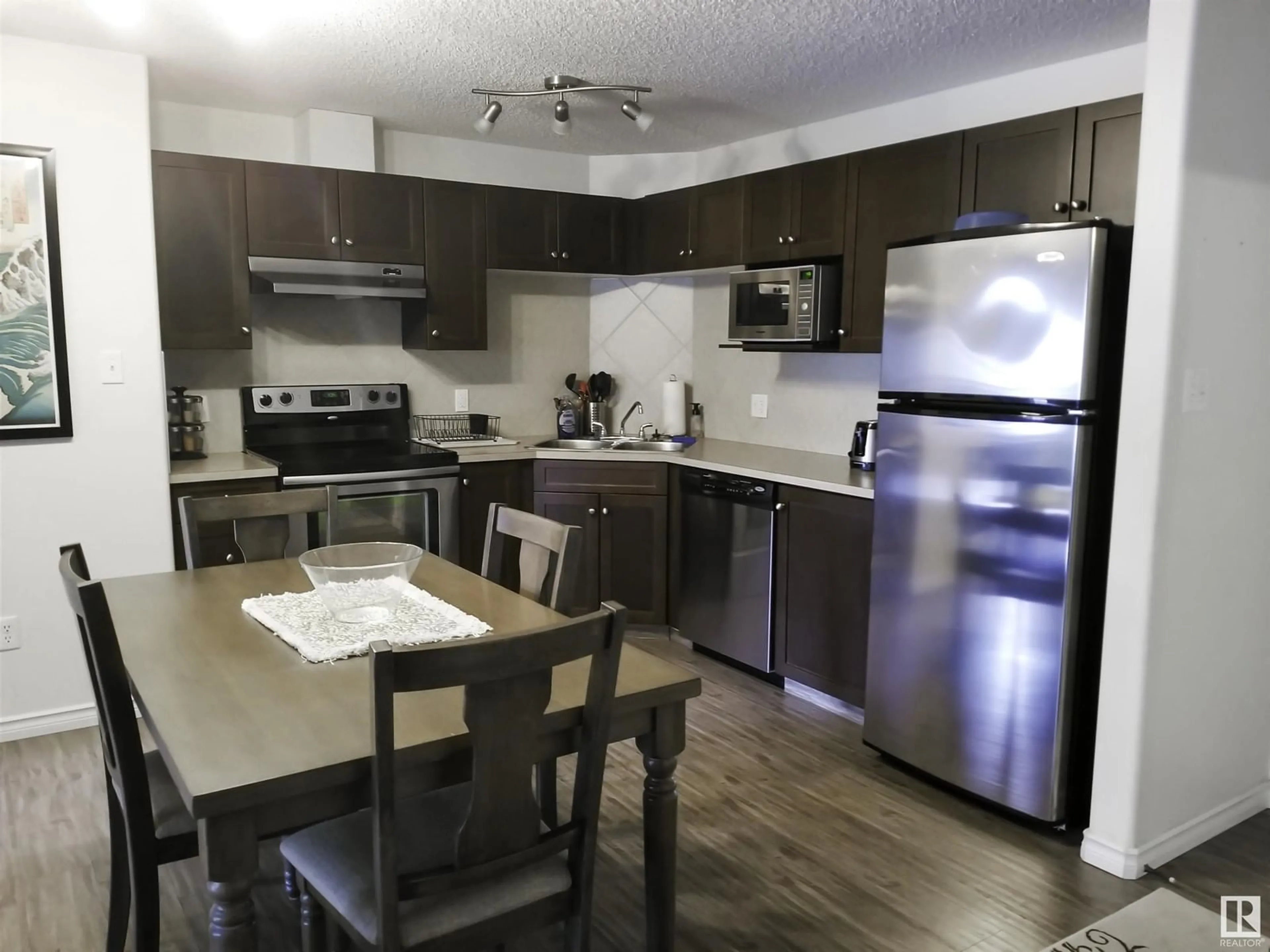 Open concept kitchen, wood/laminate floor for 9363 NW - 1332 SIMPSON DR, Edmonton Alberta T6R0N2