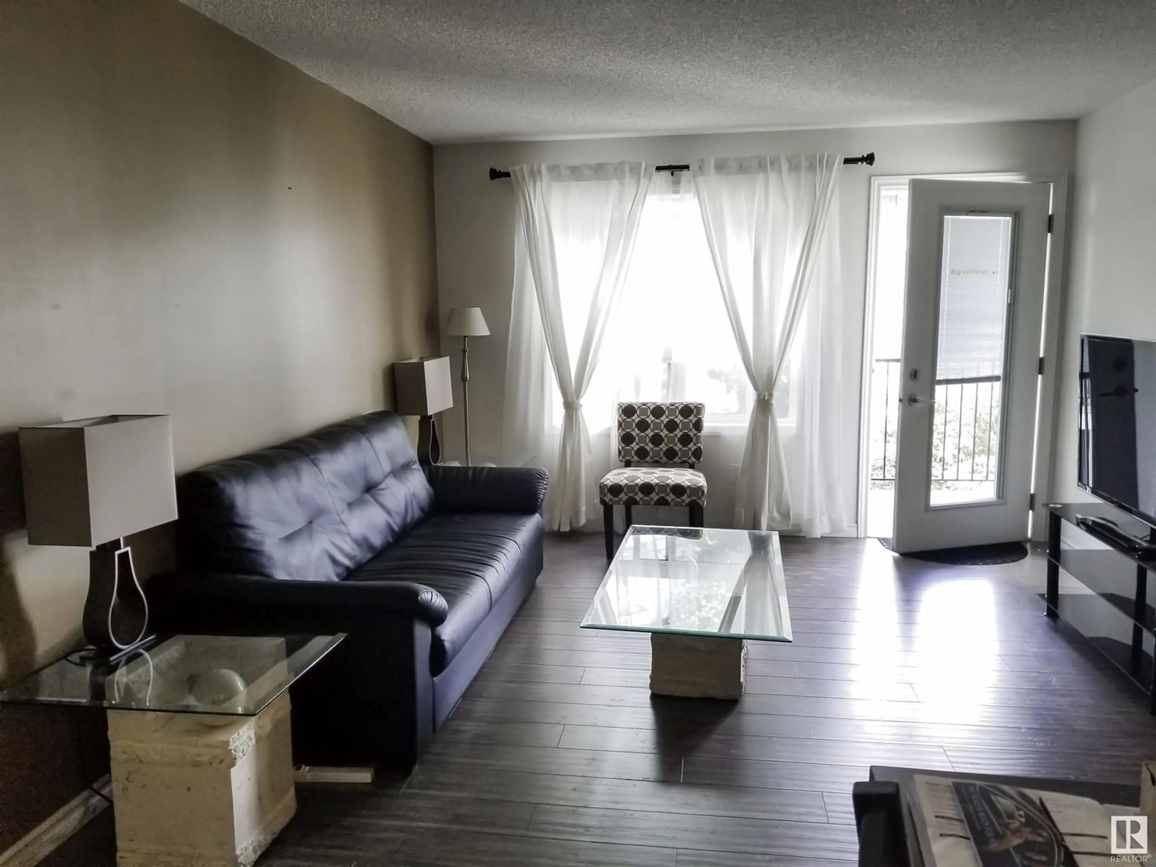 Living room with furniture, wood/laminate floor for 9363 NW - 1332 SIMPSON DR, Edmonton Alberta T6R0N2