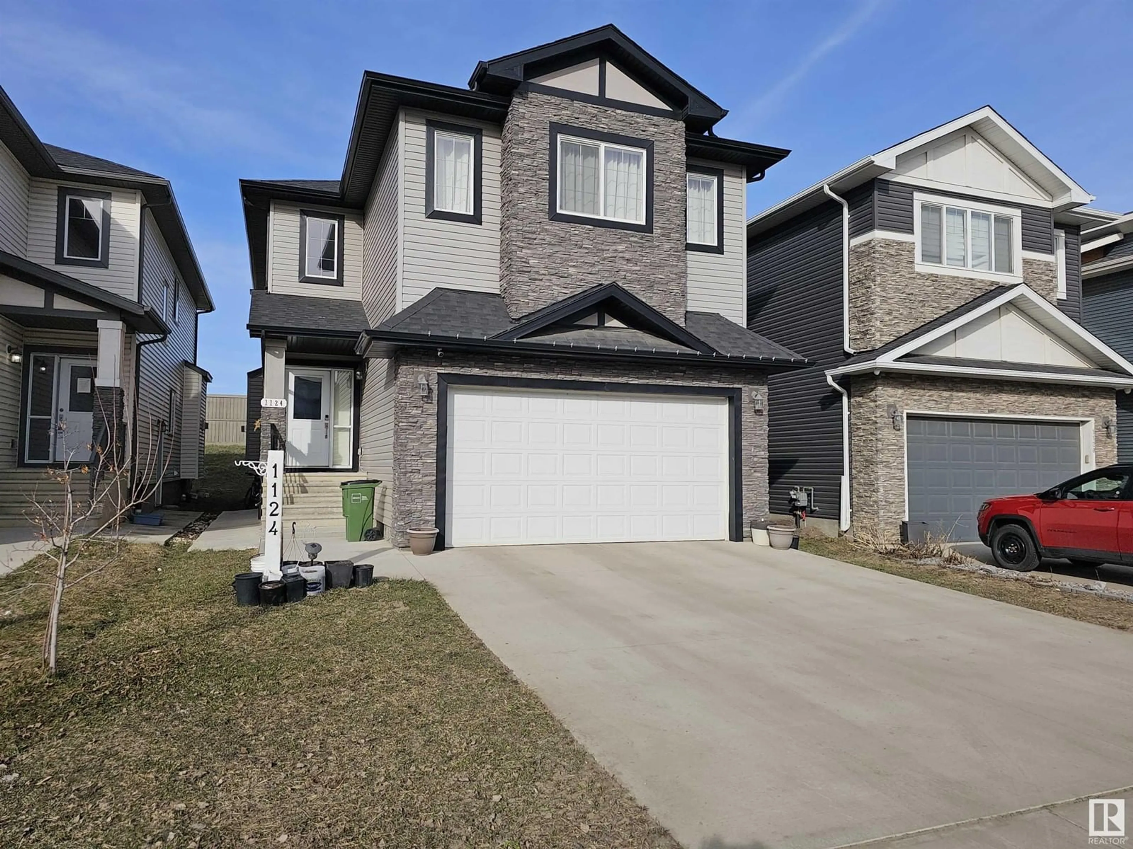 Home with vinyl exterior material, street for 1124 152 AV, Edmonton Alberta T5Y0Z5