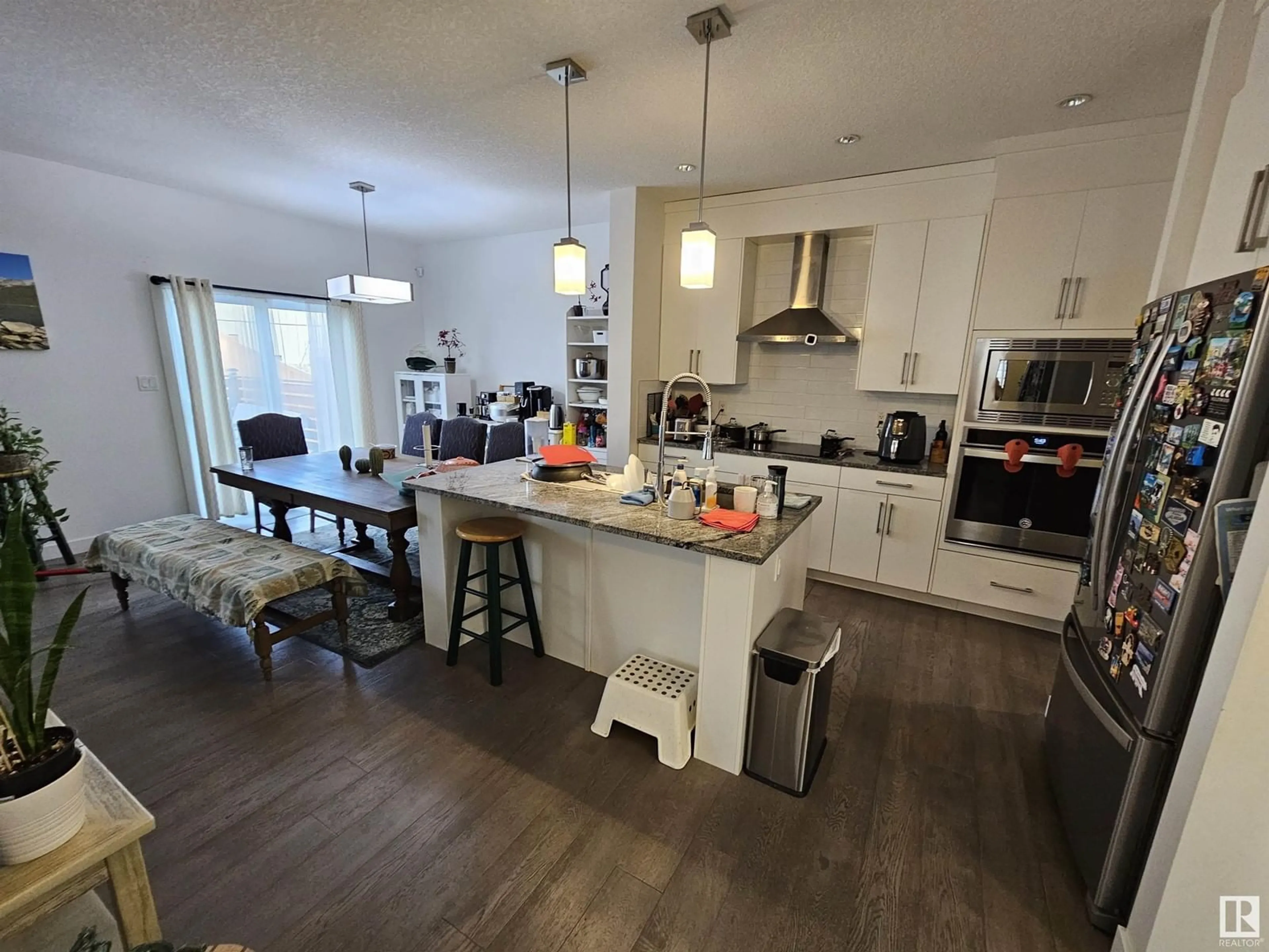 Open concept kitchen, wood/laminate floor for 1124 152 AV, Edmonton Alberta T5Y0Z5