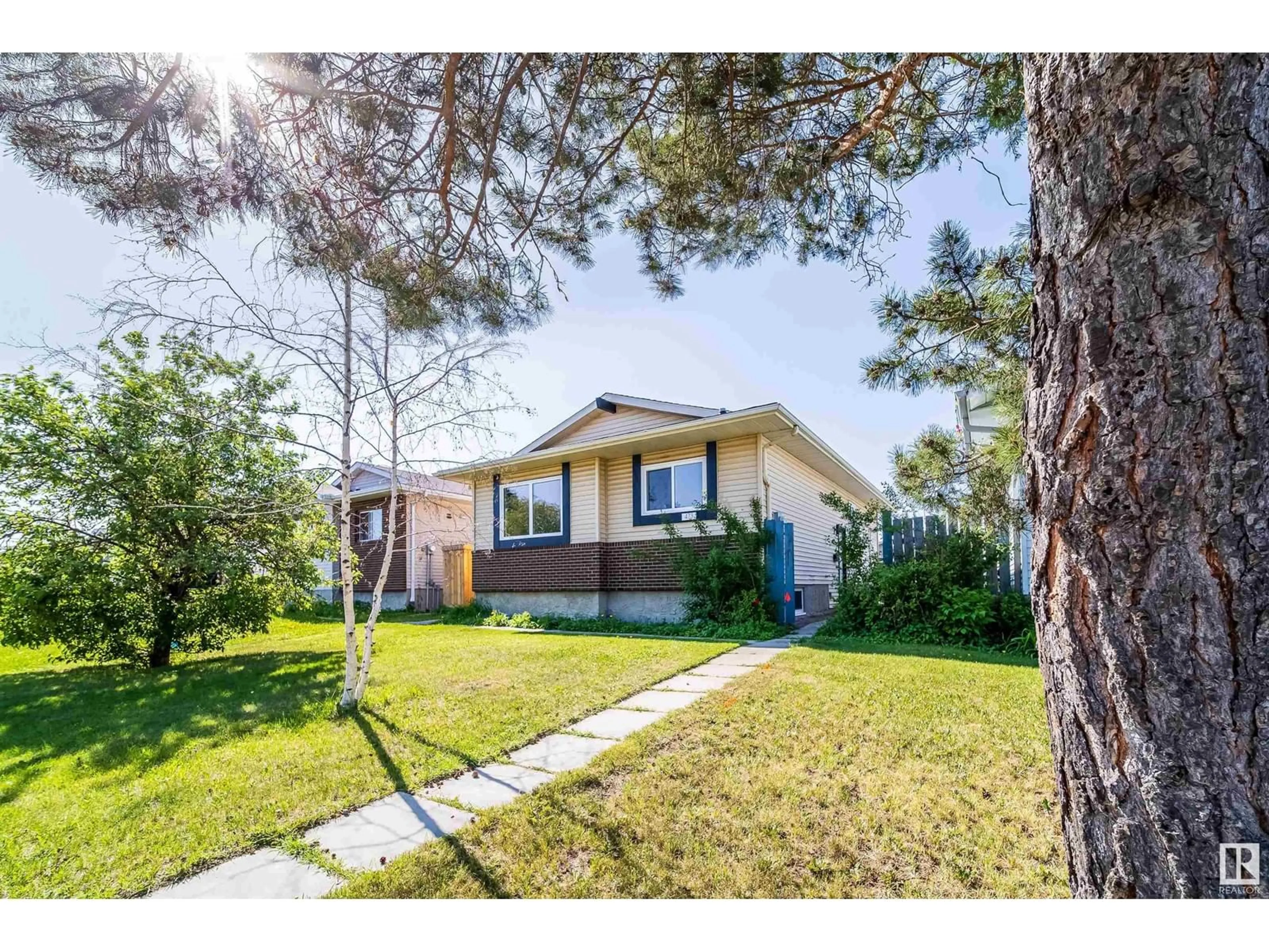 Home with vinyl exterior material, street for 473 KIRKNESS RD, Edmonton Alberta T5Y2J1