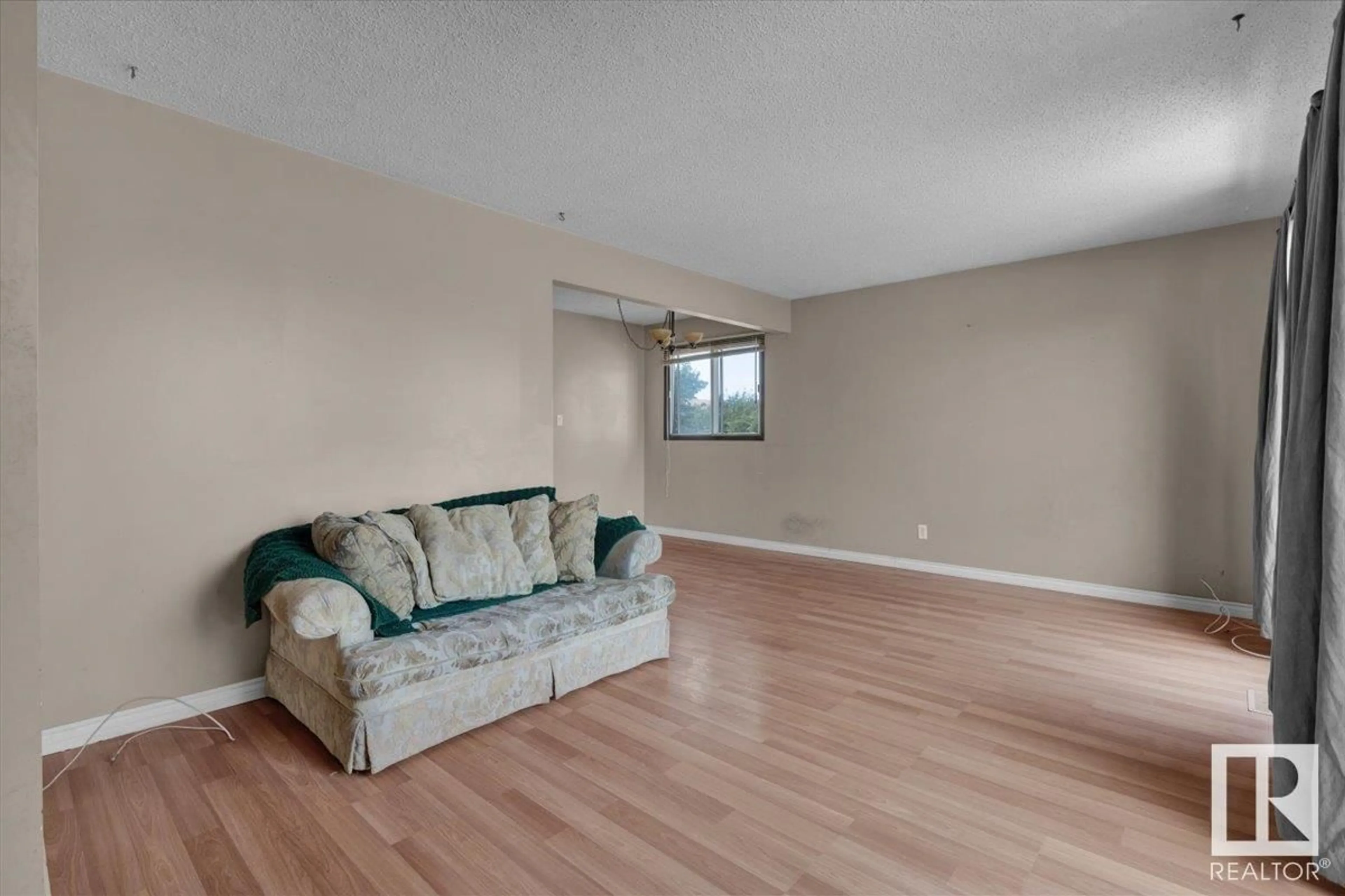 Living room with furniture, wood/laminate floor for 4320 74 ST, Edmonton Alberta T6K0W2