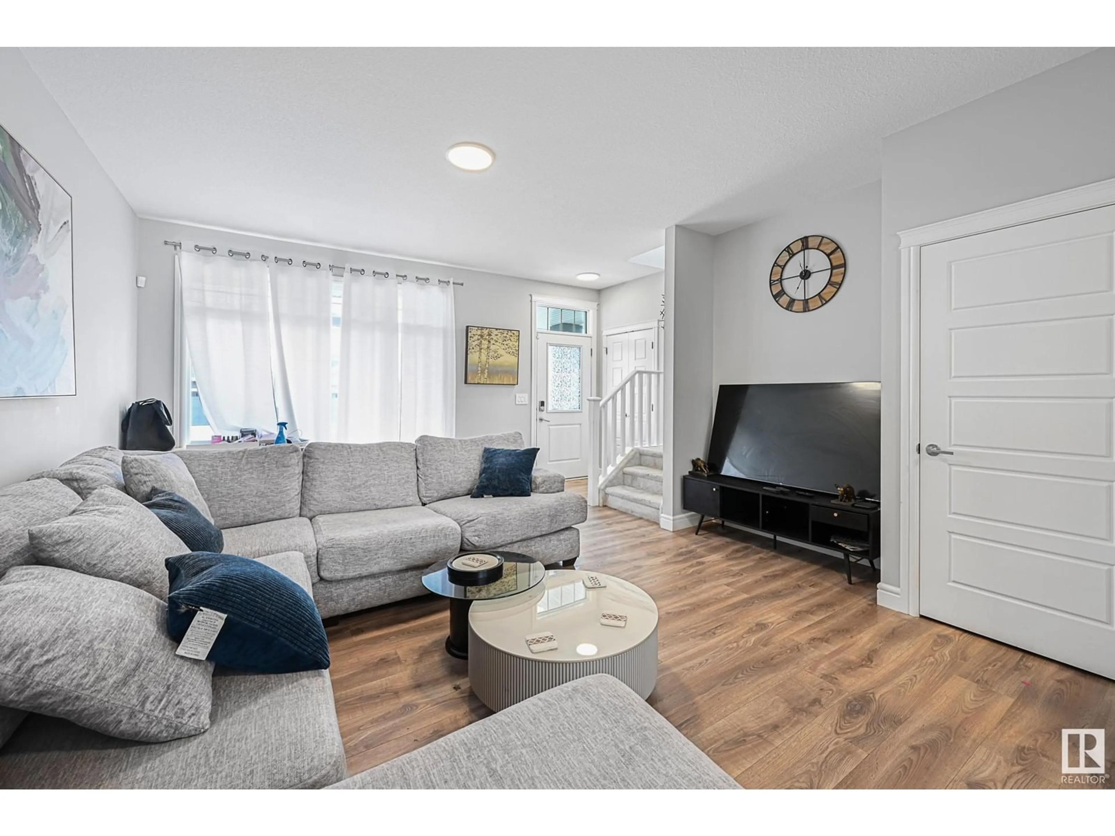 Living room with furniture, wood/laminate floor for 16703 30 AV, Edmonton Alberta T6W4P9