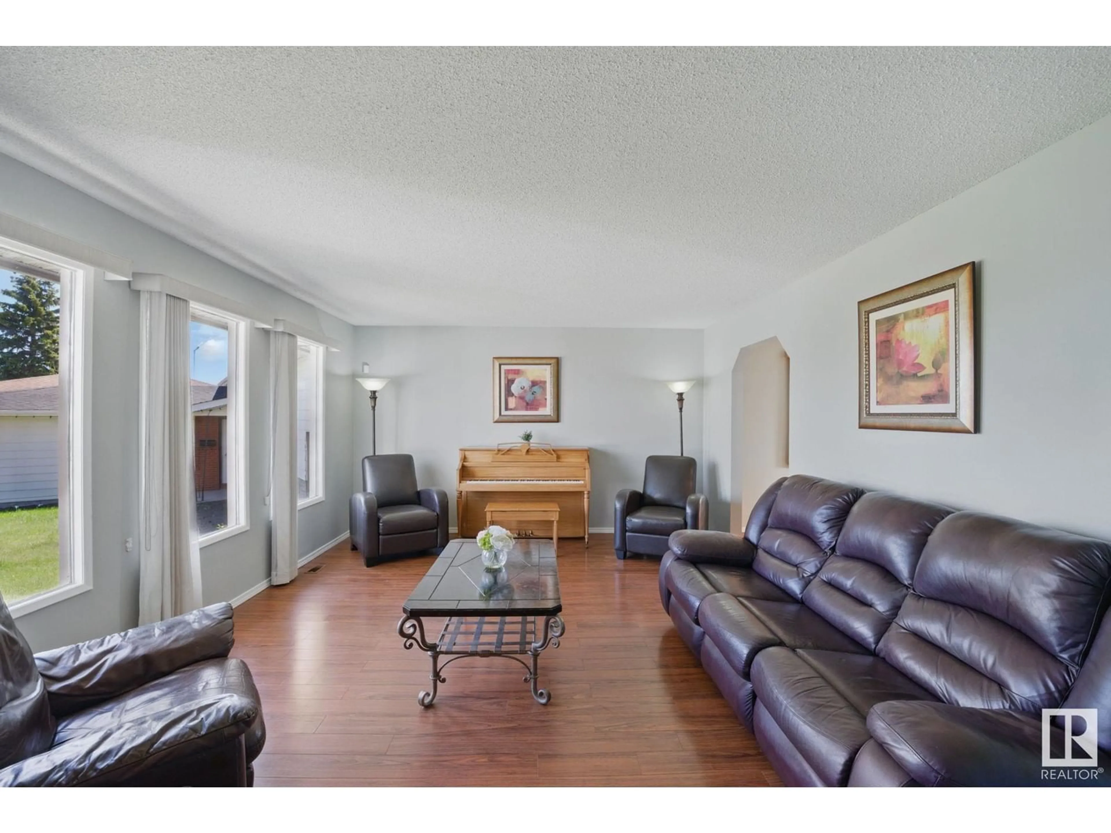 Living room with furniture, wood/laminate floor for 4336 74 ST, Edmonton Alberta T6K0W2
