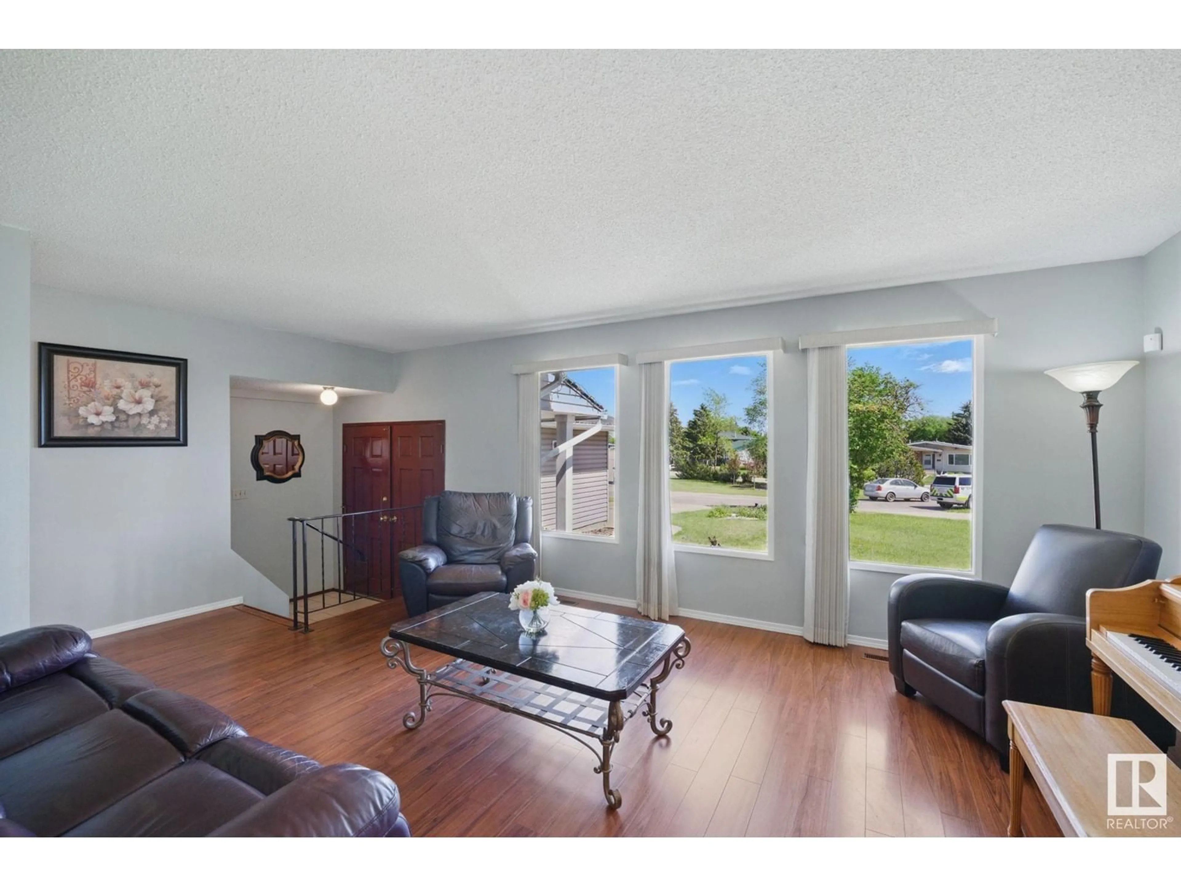 Living room with furniture, wood/laminate floor for 4336 74 ST, Edmonton Alberta T6K0W2
