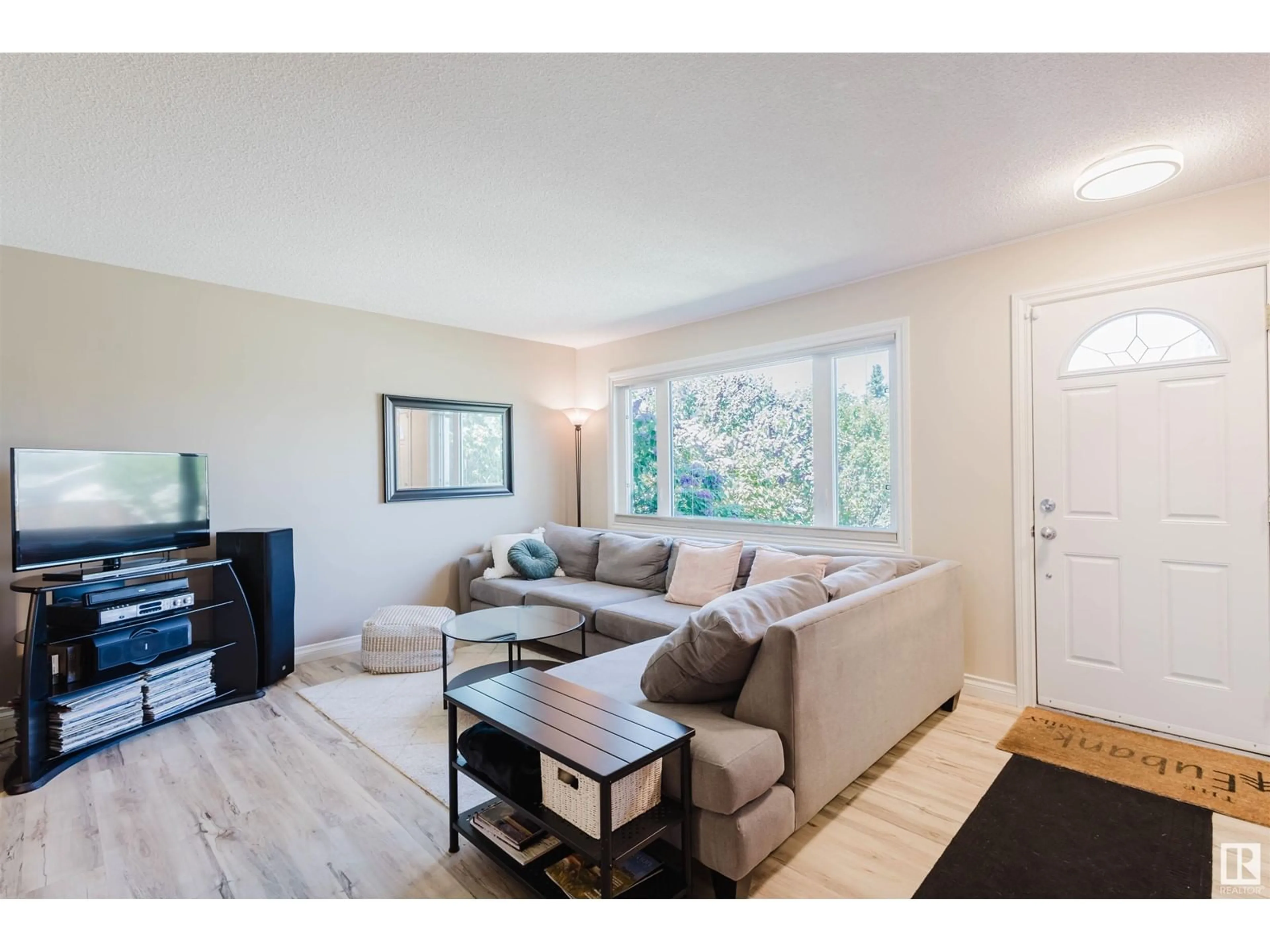 Living room with furniture, wood/laminate floor for NW - 5507 92A AV, Edmonton Alberta T6B0S9