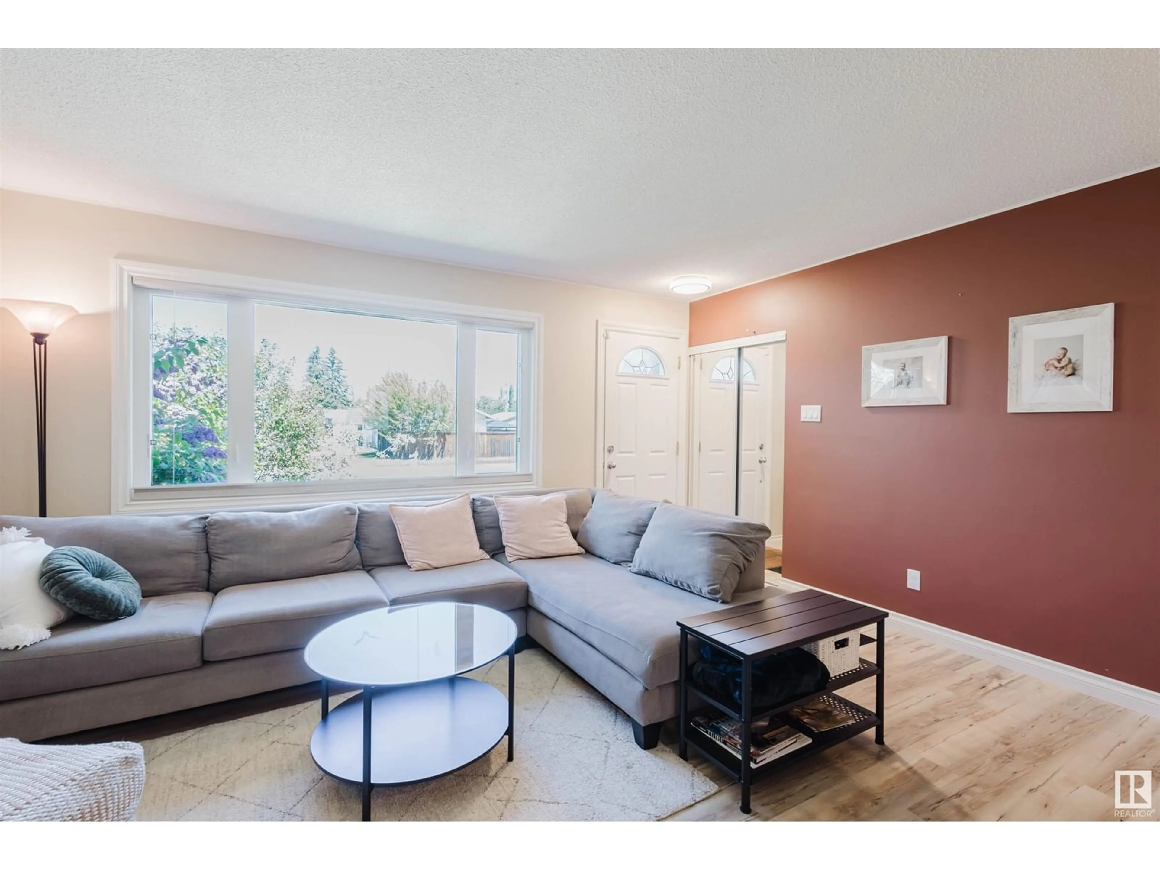 Living room with furniture, wood/laminate floor for NW - 5507 92A AV, Edmonton Alberta T6B0S9