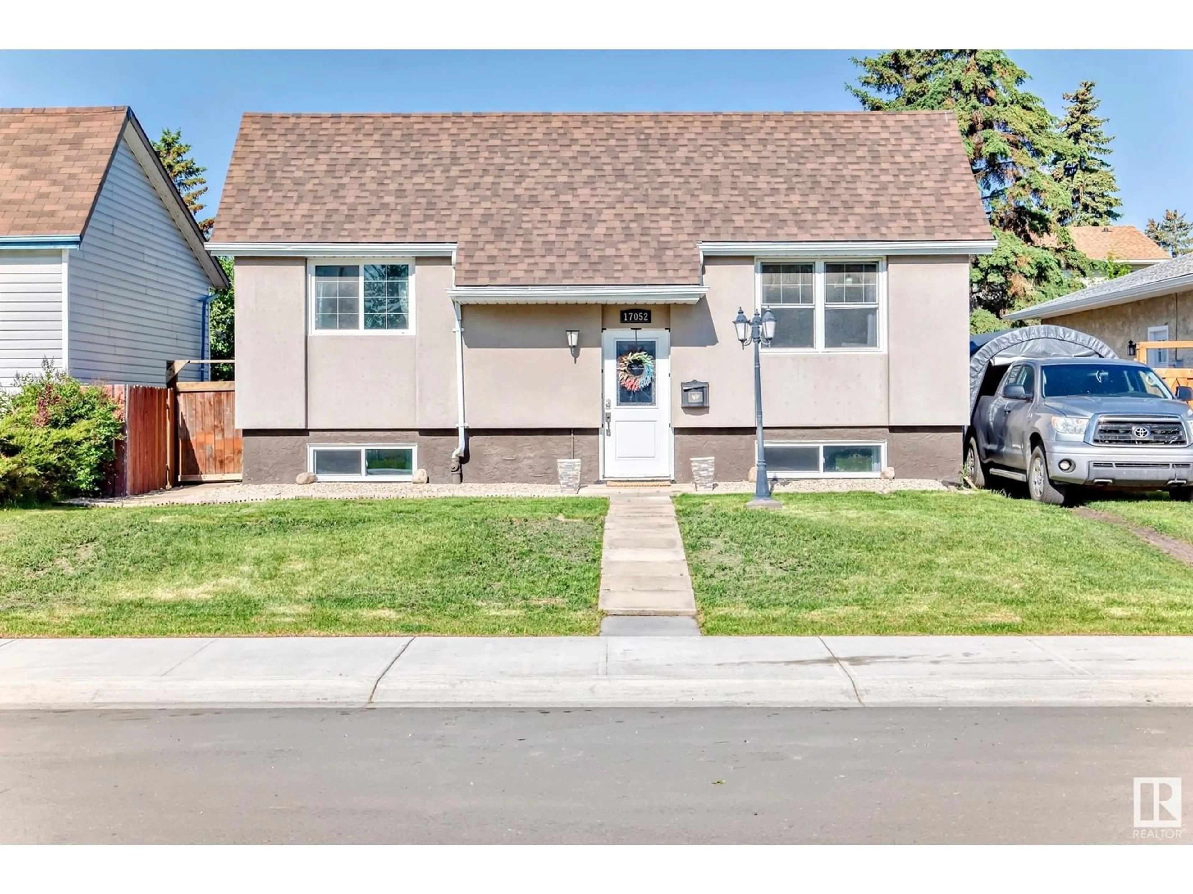 Home with vinyl exterior material, street for 17052 98 ST, Edmonton Alberta T5X3G6