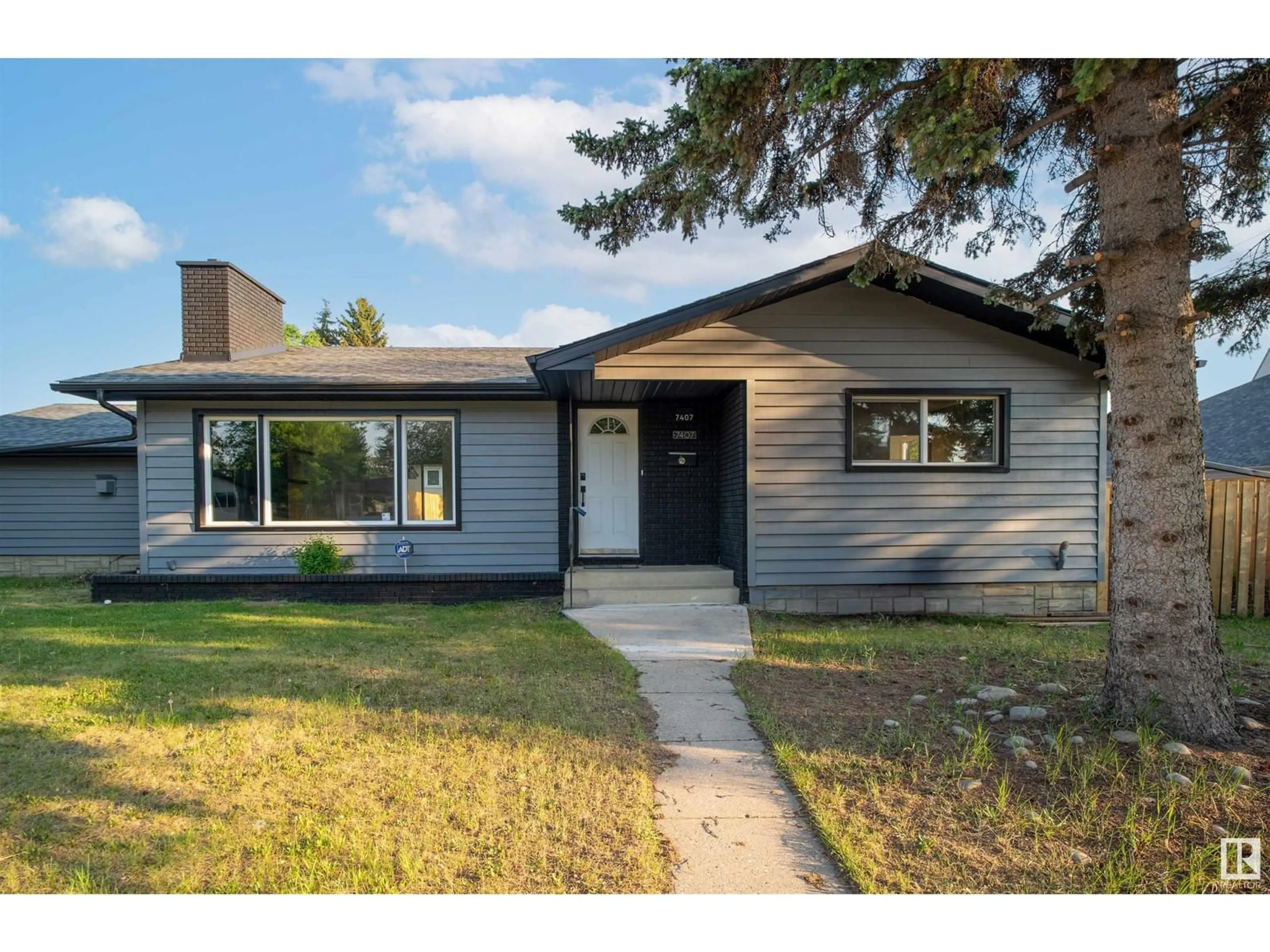 Home with vinyl exterior material, street for 7407 92 AV, Edmonton Alberta T6B0S8