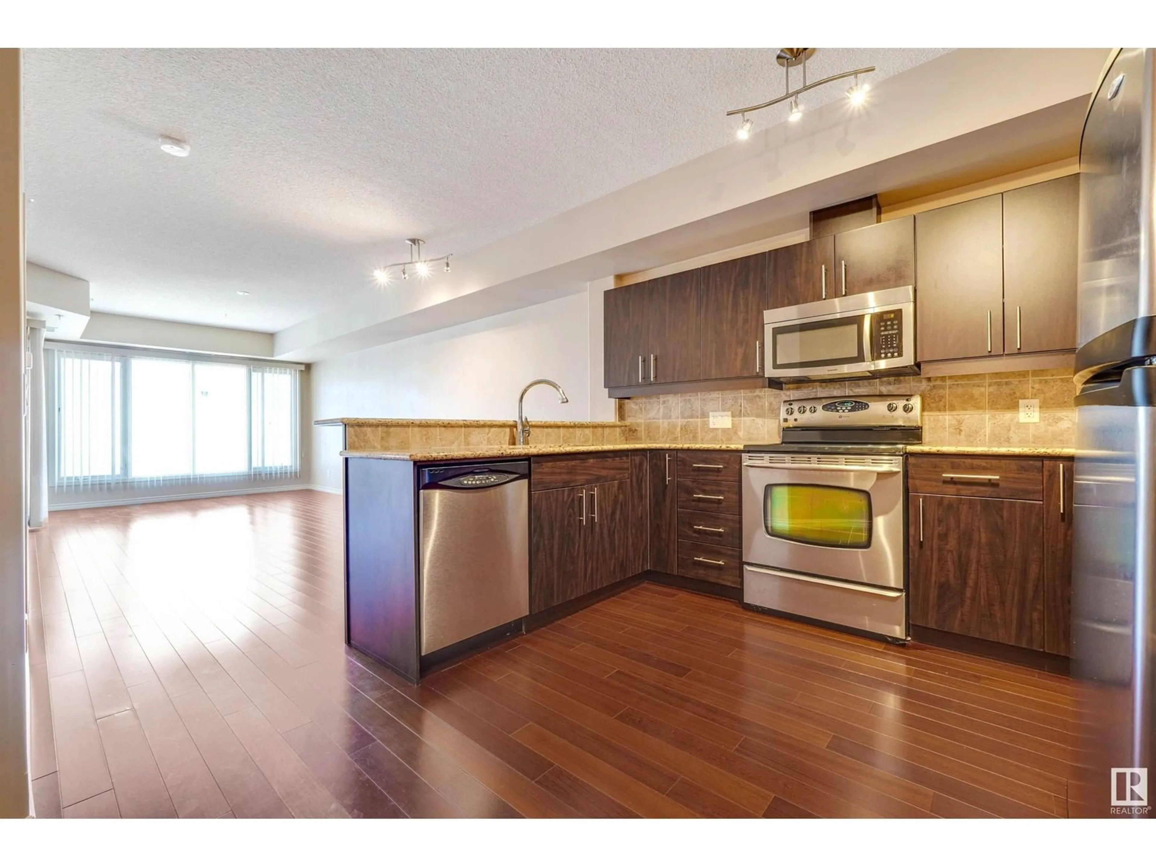 Open concept kitchen, wood/laminate floor for 10303 - 508 111 ST NW, Edmonton Alberta T5K0C6