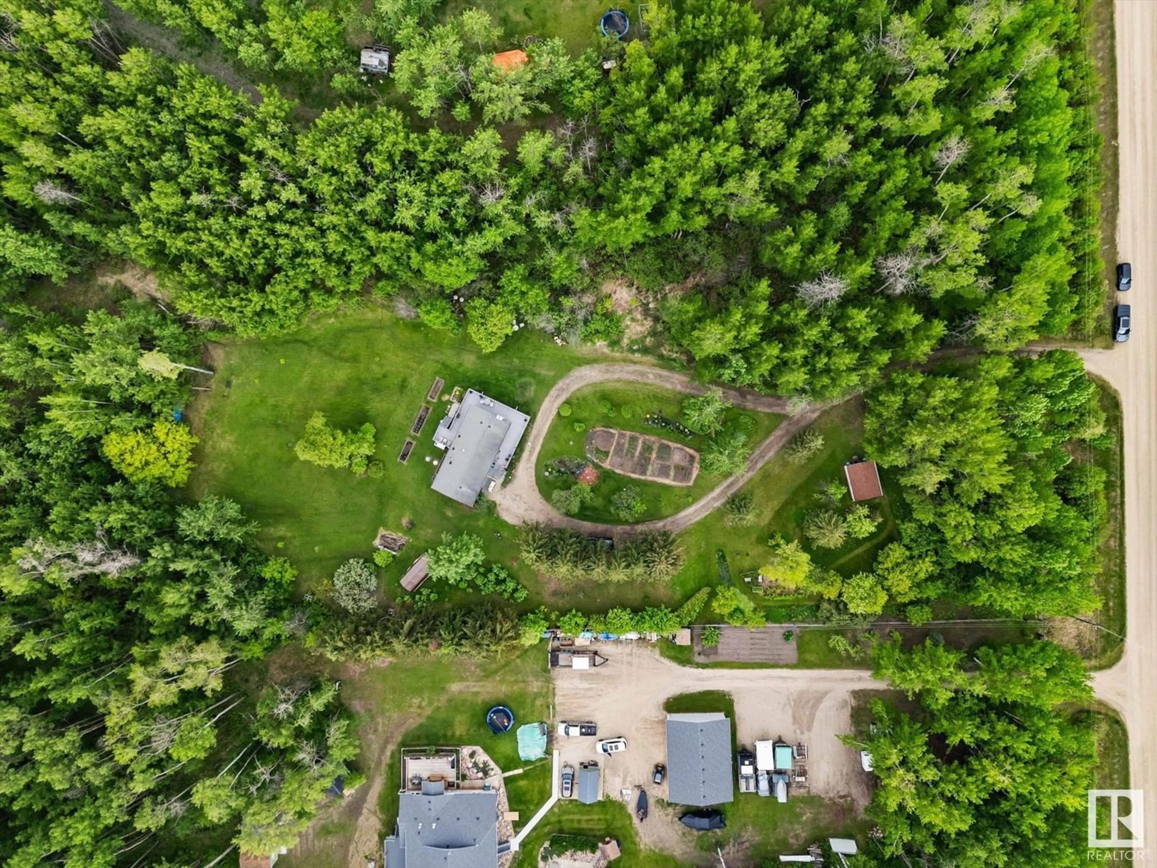 A pic from outside/outdoor area/front of a property/back of a property/a pic from drone, forest/trees view for 202 - 53320 RGE ROAD 30, Rural Parkland County Alberta T7Y0E2