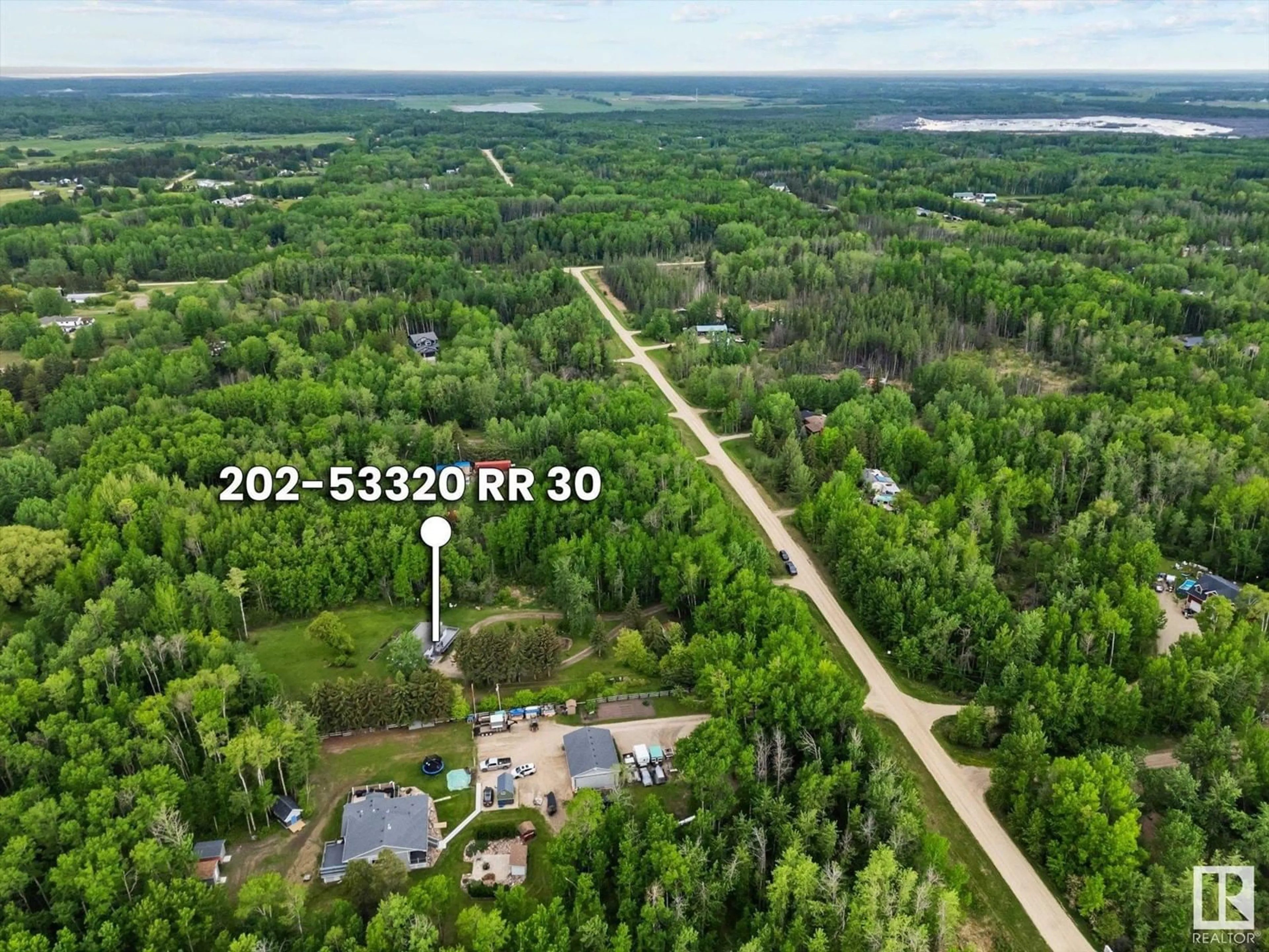 A pic from outside/outdoor area/front of a property/back of a property/a pic from drone, forest/trees view for 202 - 53320 RGE ROAD 30, Rural Parkland County Alberta T7Y0E2