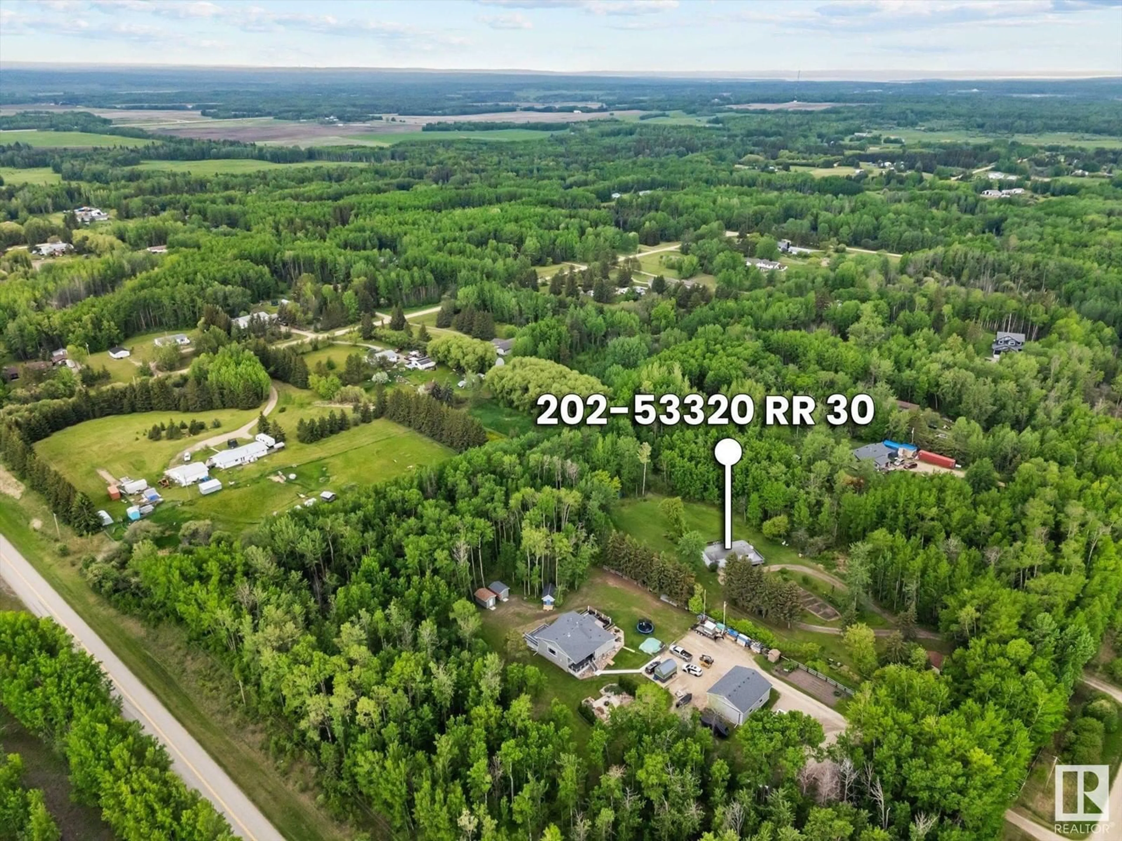 A pic from outside/outdoor area/front of a property/back of a property/a pic from drone, forest/trees view for 202 - 53320 RGE ROAD 30, Rural Parkland County Alberta T7Y0E2