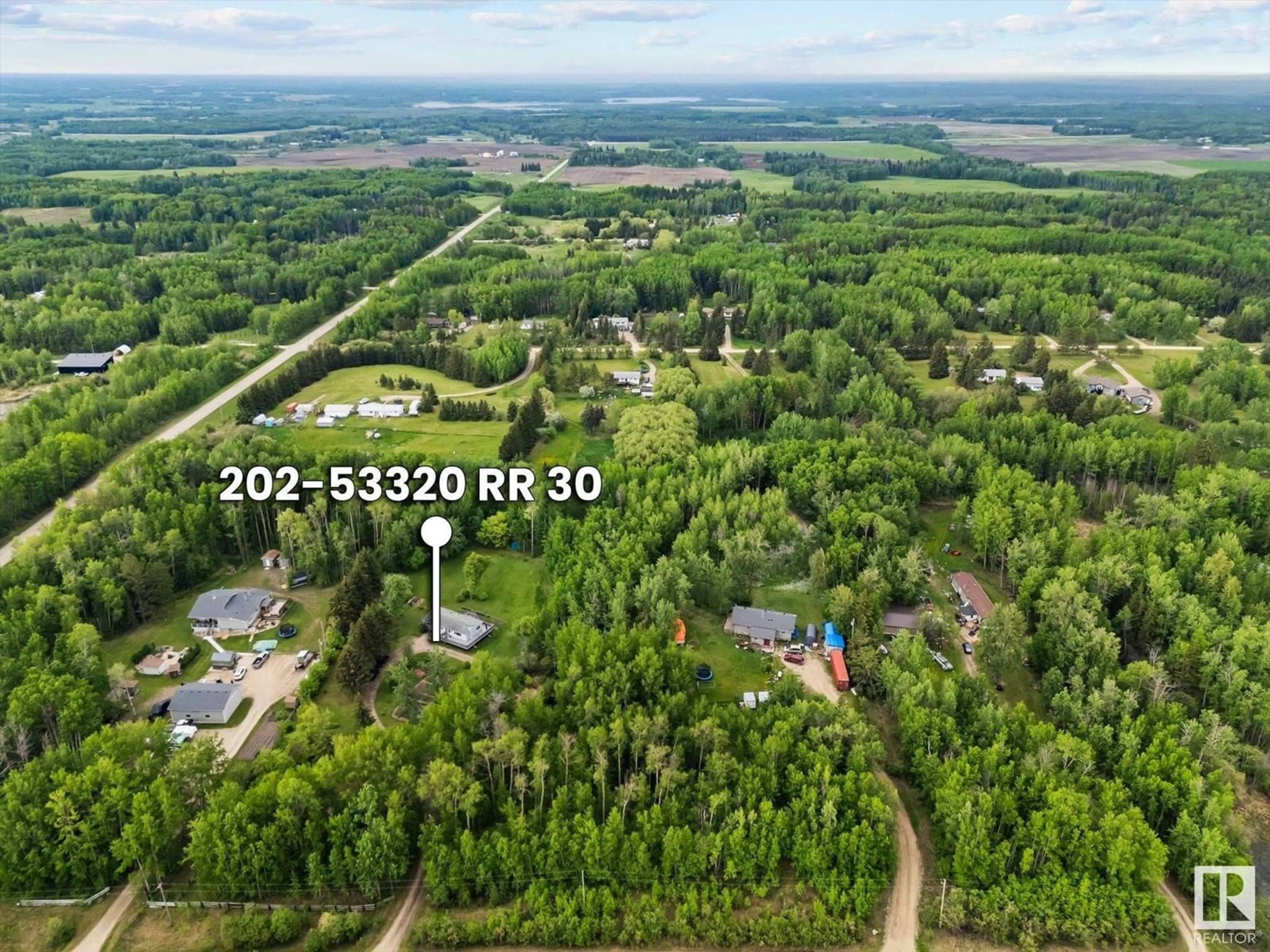 A pic from outside/outdoor area/front of a property/back of a property/a pic from drone, forest/trees view for 202 - 53320 RGE ROAD 30, Rural Parkland County Alberta T7Y0E2