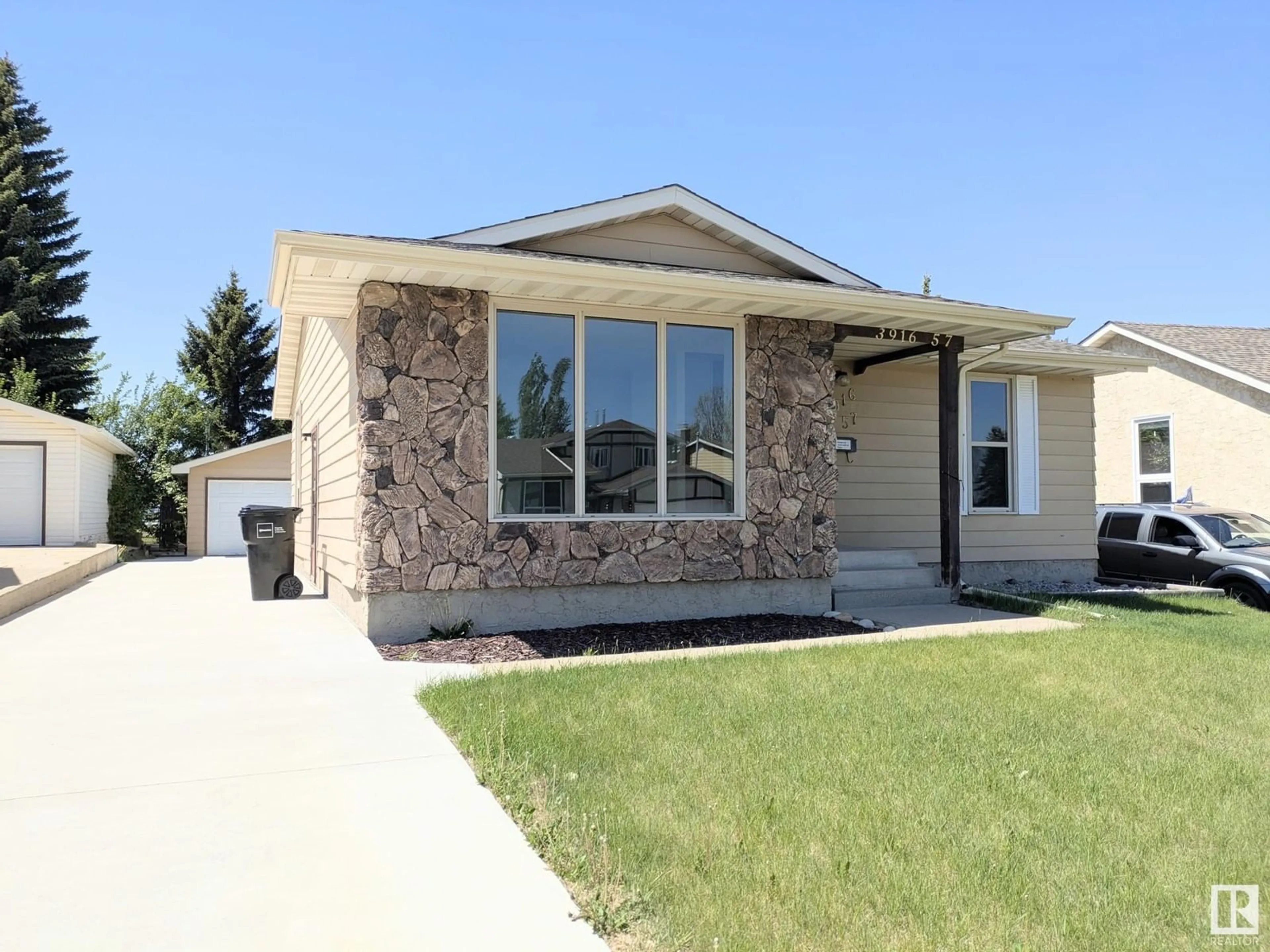 Home with vinyl exterior material, street for 3916 57 ST, Edmonton Alberta T6L1B6