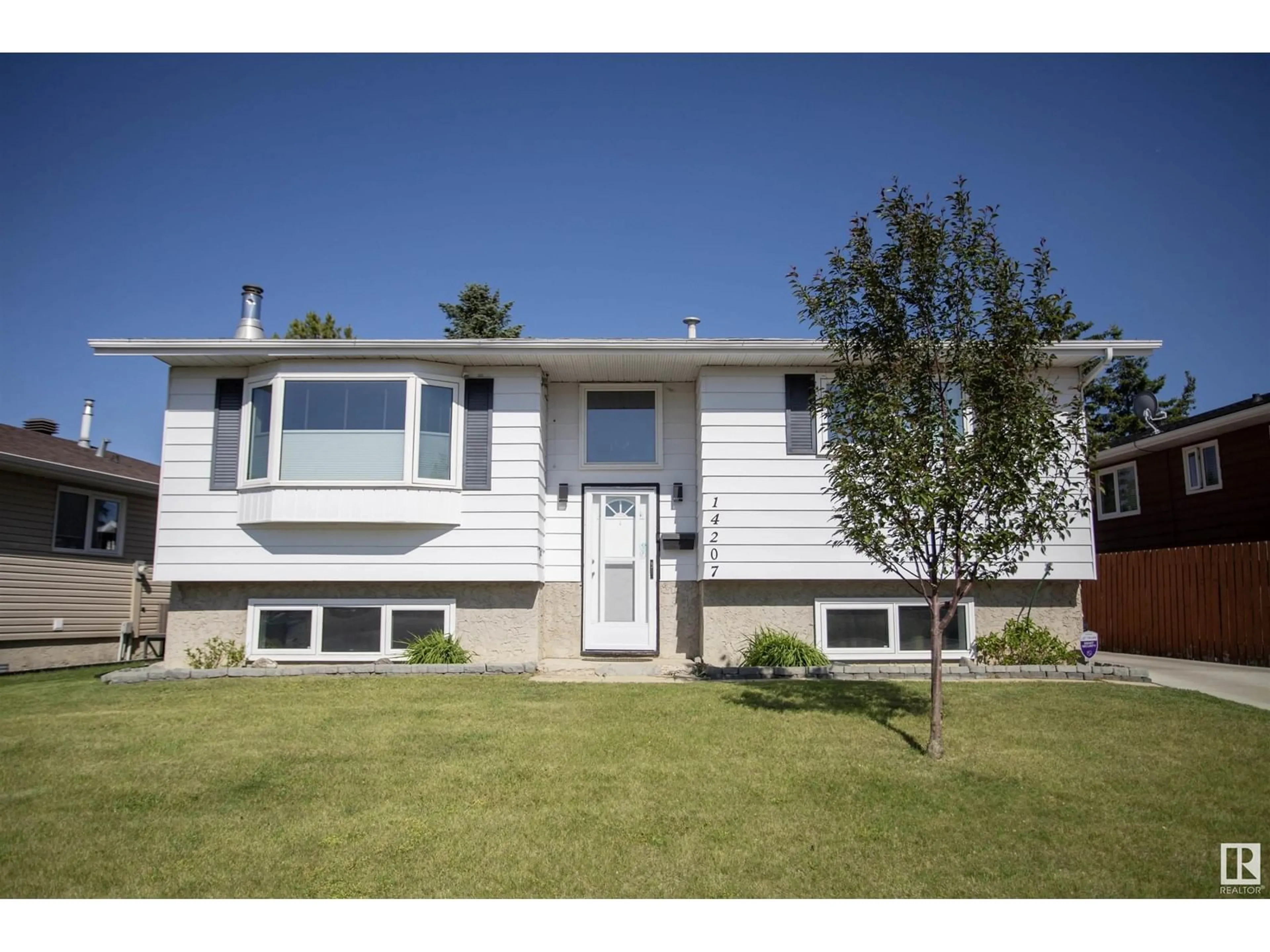 Home with vinyl exterior material, street for 14207 25 ST, Edmonton Alberta T5Y1G4