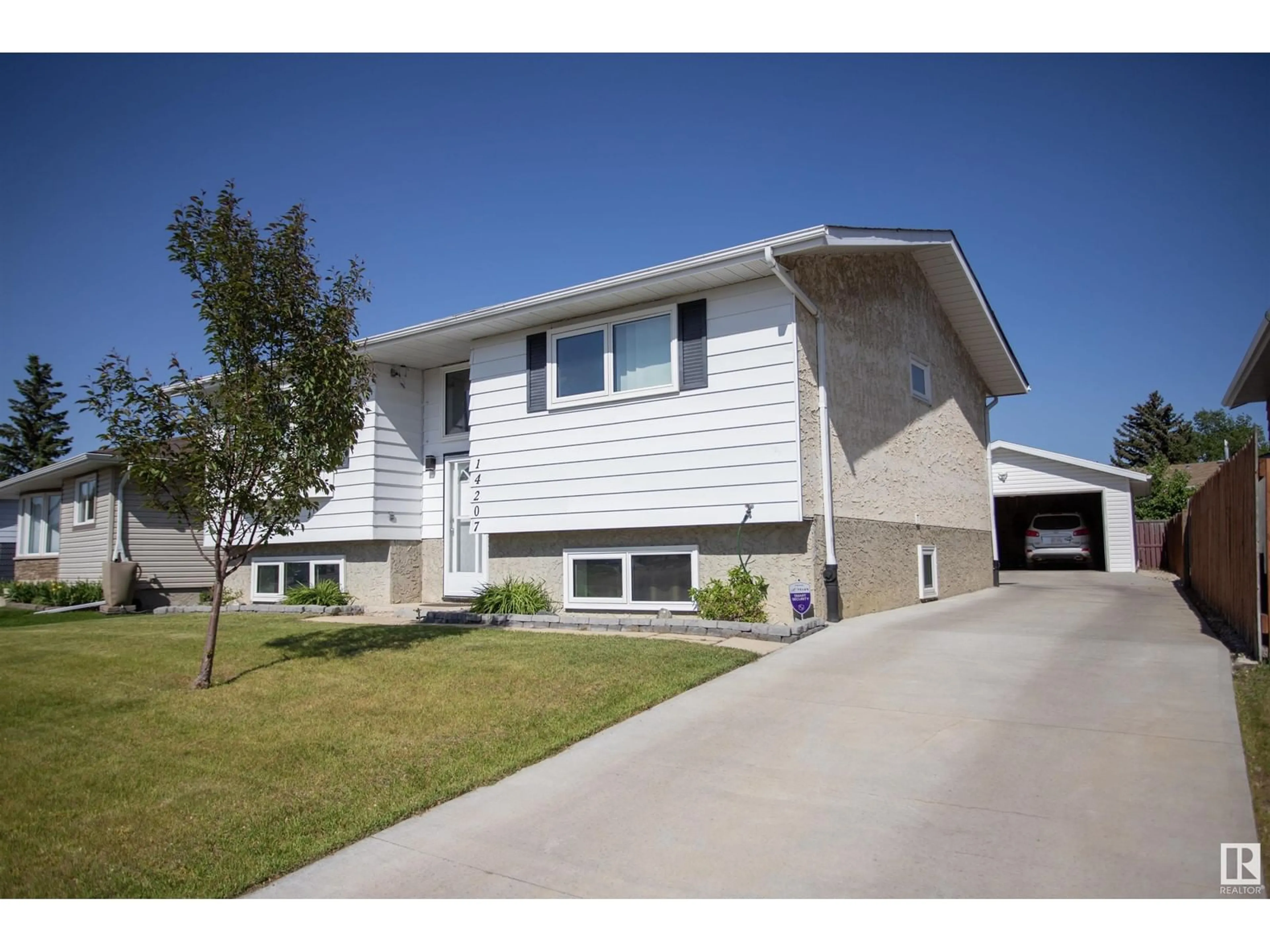 Home with vinyl exterior material, street for 14207 25 ST, Edmonton Alberta T5Y1G4