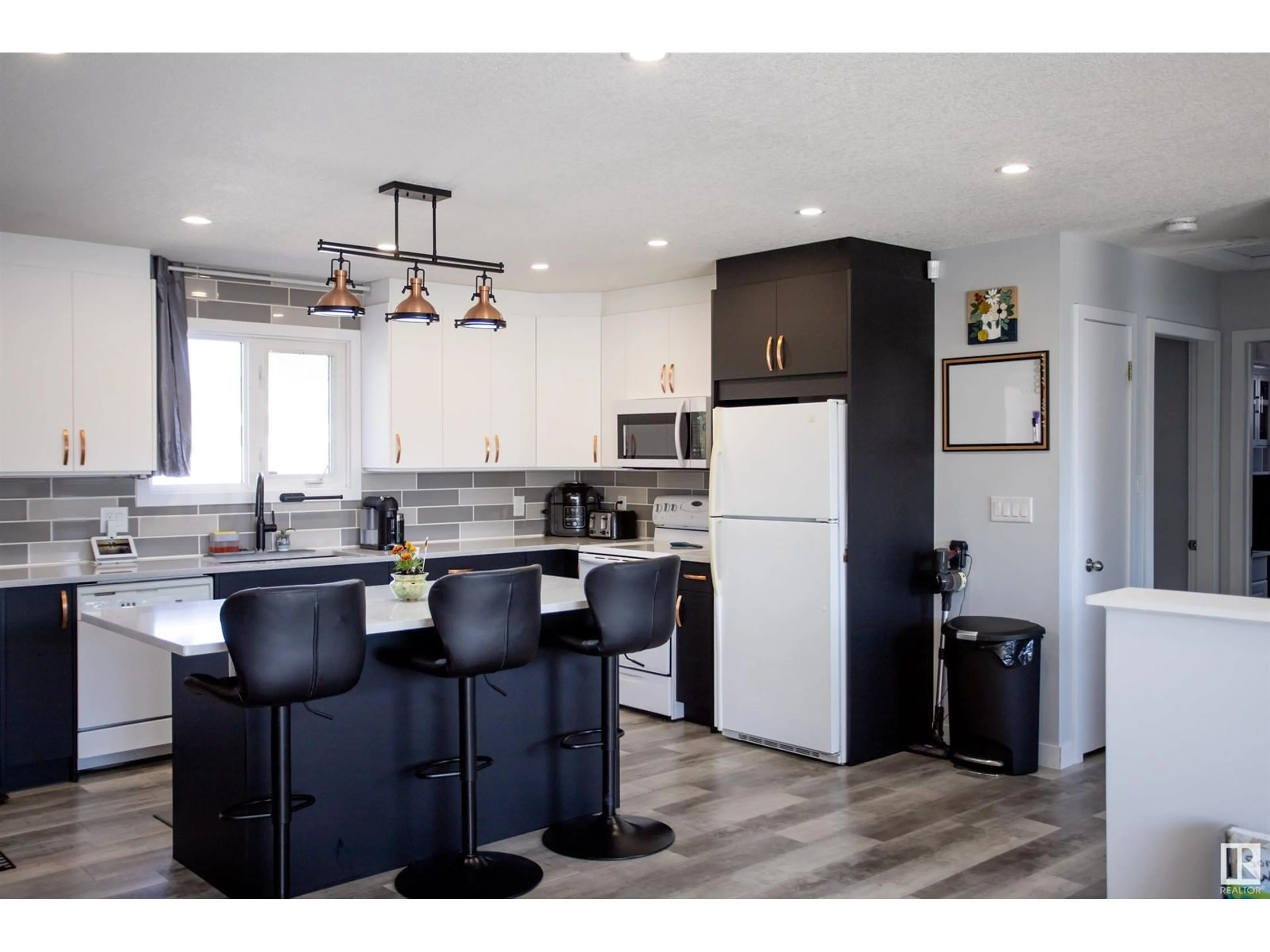 Open concept kitchen, wood/laminate floor for 14207 25 ST, Edmonton Alberta T5Y1G4
