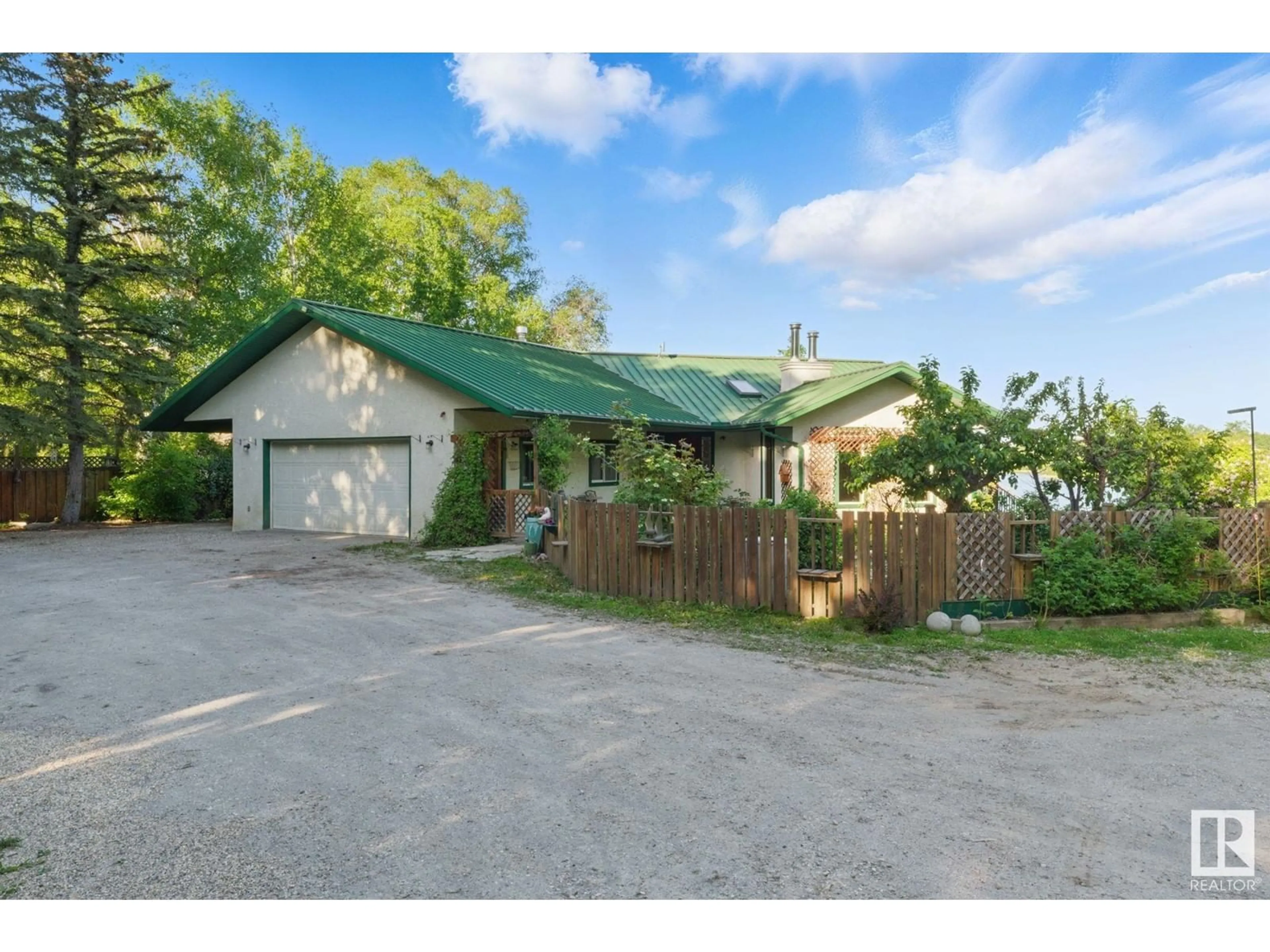 A pic from outside/outdoor area/front of a property/back of a property/a pic from drone, street for 27 - 53117 RGE ROAD 14, Rural Parkland County Alberta T7Y2T3