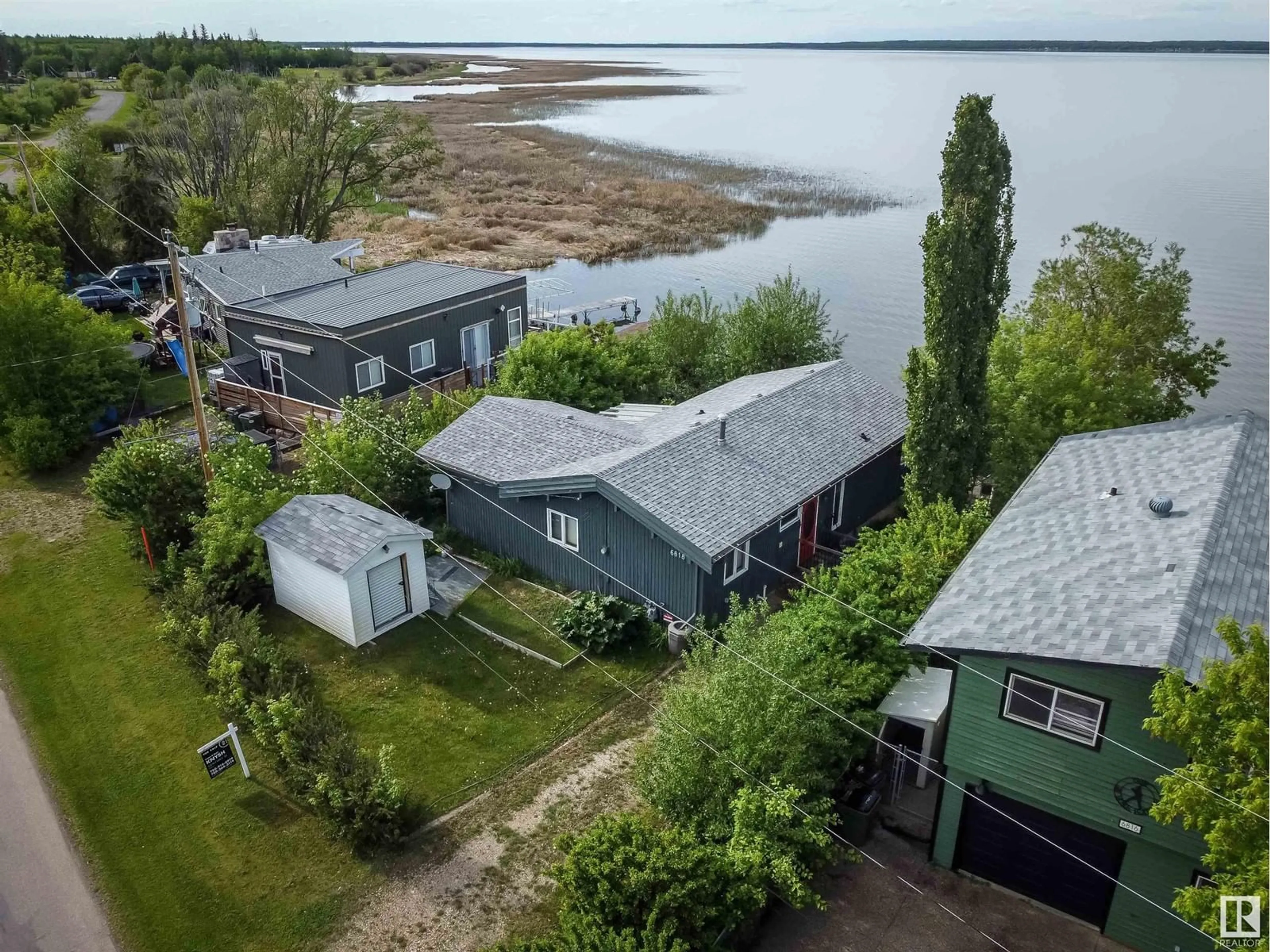 A pic from outside/outdoor area/front of a property/back of a property/a pic from drone, water/lake/river/ocean view for 6818 50 AV, Rural Lac Ste. Anne County Alberta T0E0A0