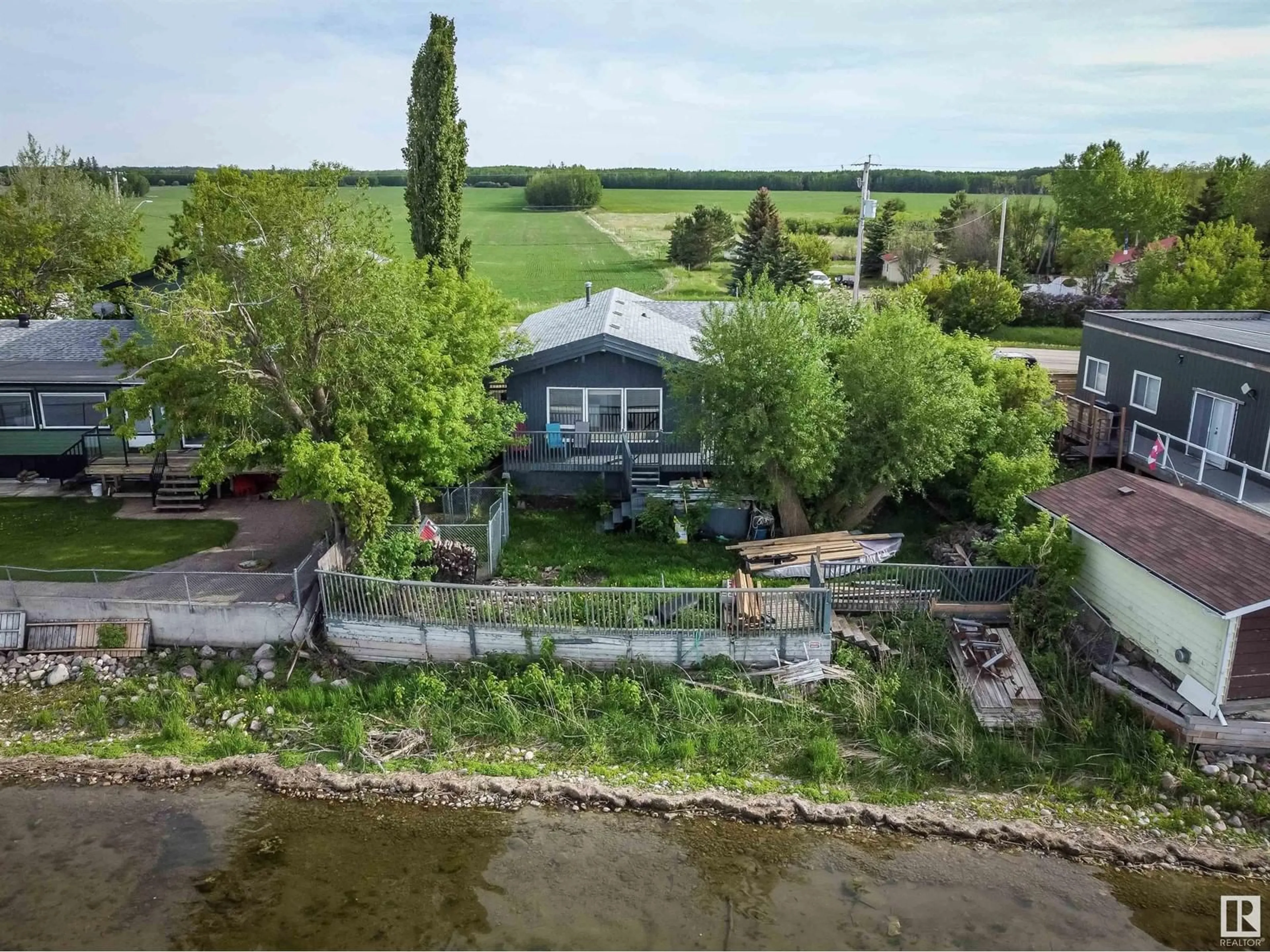 A pic from outside/outdoor area/front of a property/back of a property/a pic from drone, water/lake/river/ocean view for 6818 50 AV, Rural Lac Ste. Anne County Alberta T0E0A0