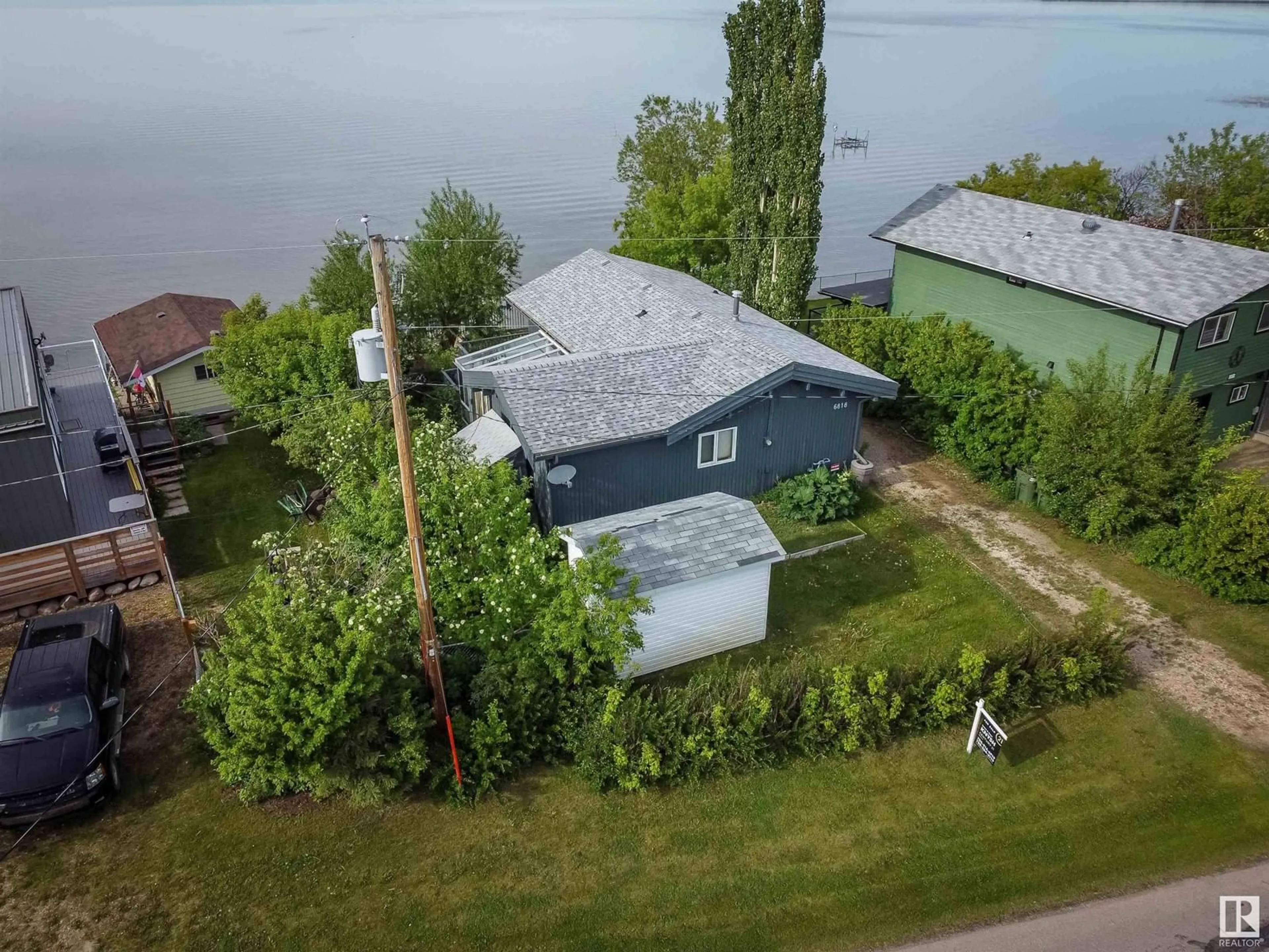 A pic from outside/outdoor area/front of a property/back of a property/a pic from drone, water/lake/river/ocean view for 6818 50 AV, Rural Lac Ste. Anne County Alberta T0E0A0