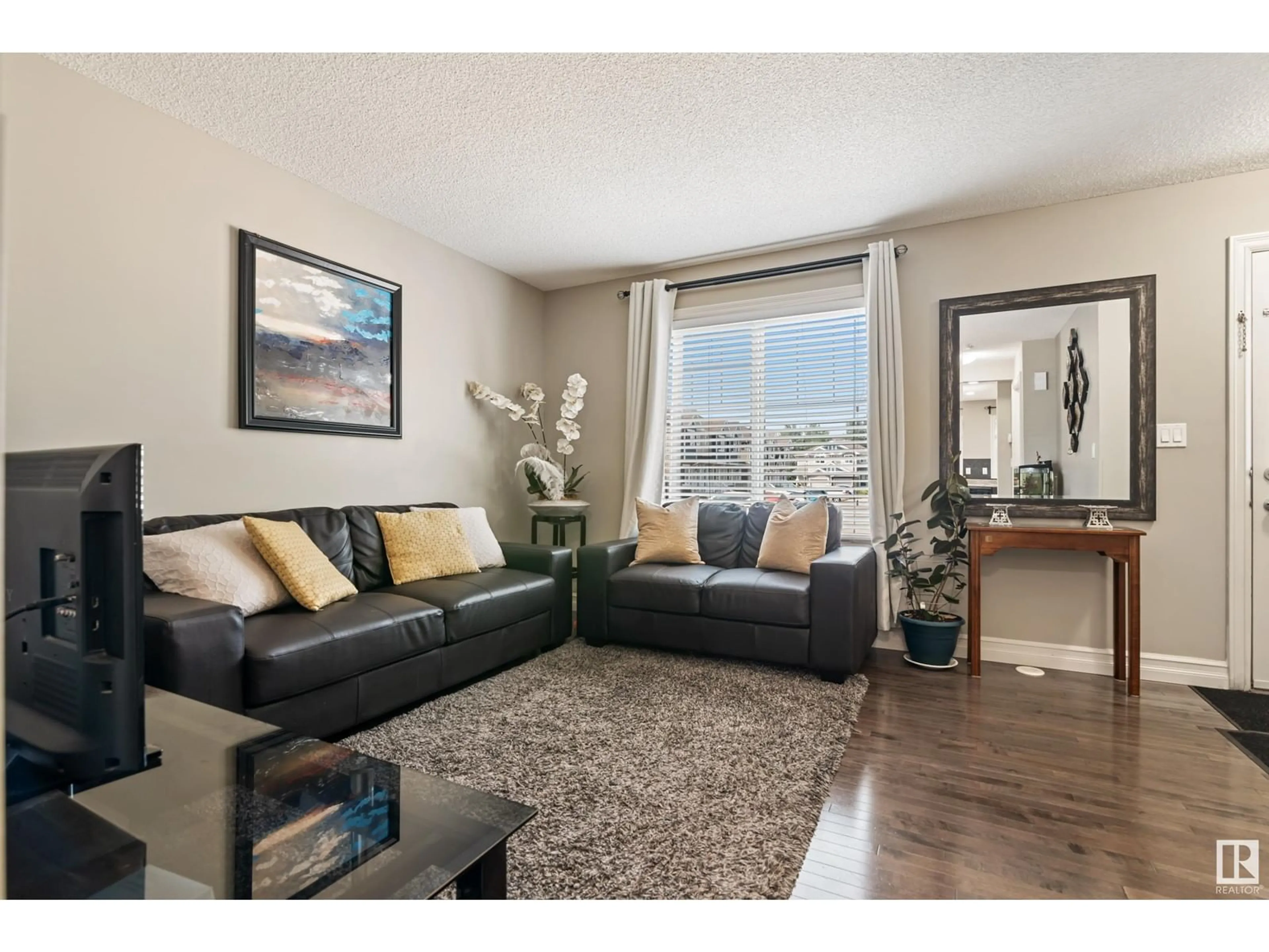 Living room with furniture, wood/laminate floor for 219 - 137 CHARLOTTE WY, Sherwood Park Alberta T8H0T3