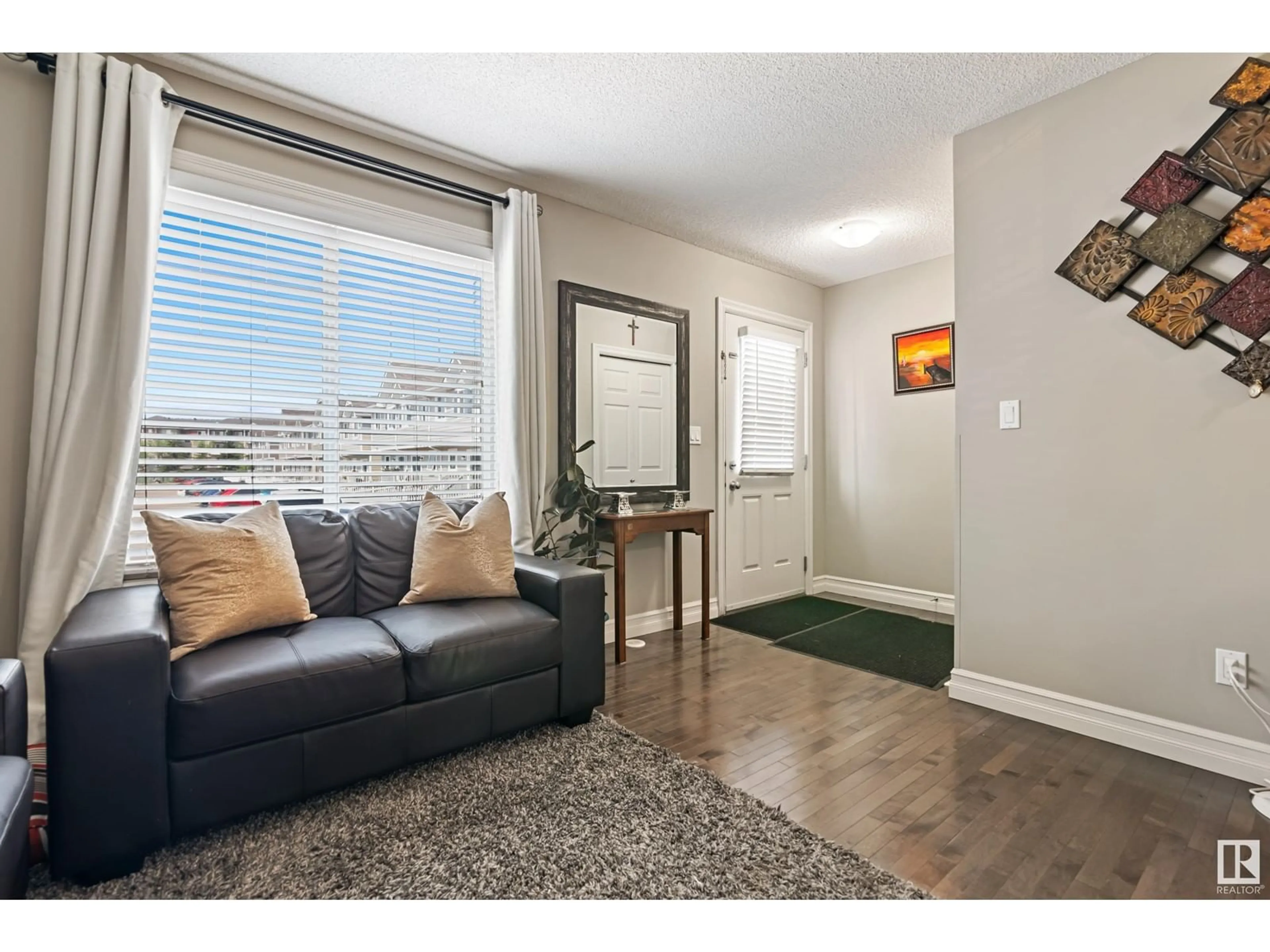 Living room with furniture, wood/laminate floor for 219 - 137 CHARLOTTE WY, Sherwood Park Alberta T8H0T3