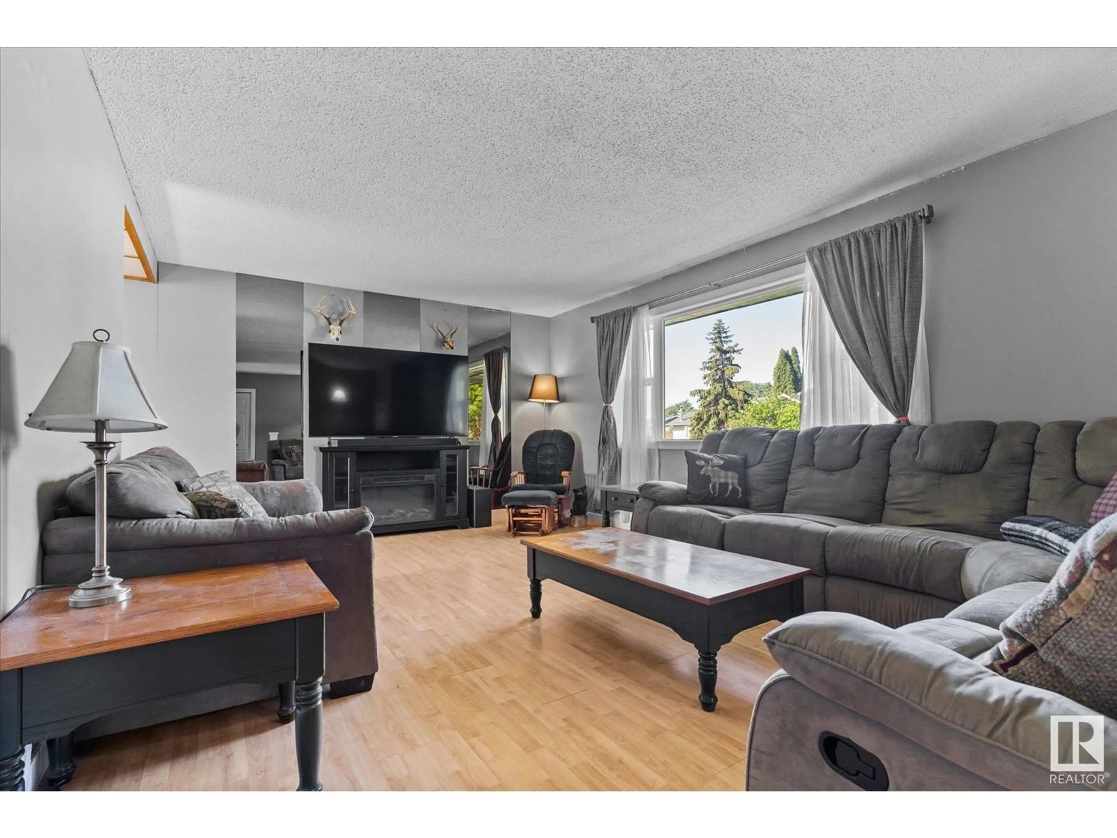 Living room with furniture, wood/laminate floor for 49 BRAZEAU DR, Devon Alberta T9G1M3