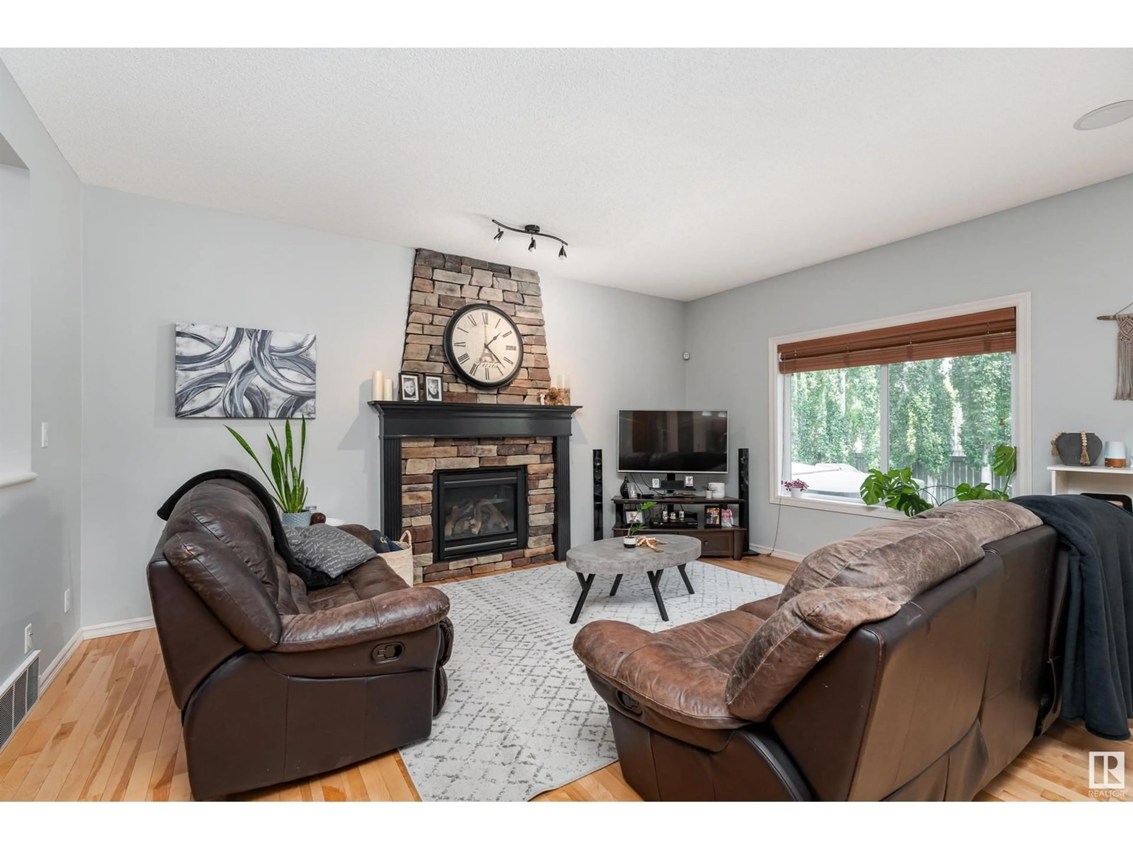 Living room with furniture, wood/laminate floor for 57 WHISTLER PL, Fort Saskatchewan Alberta T8L0B6