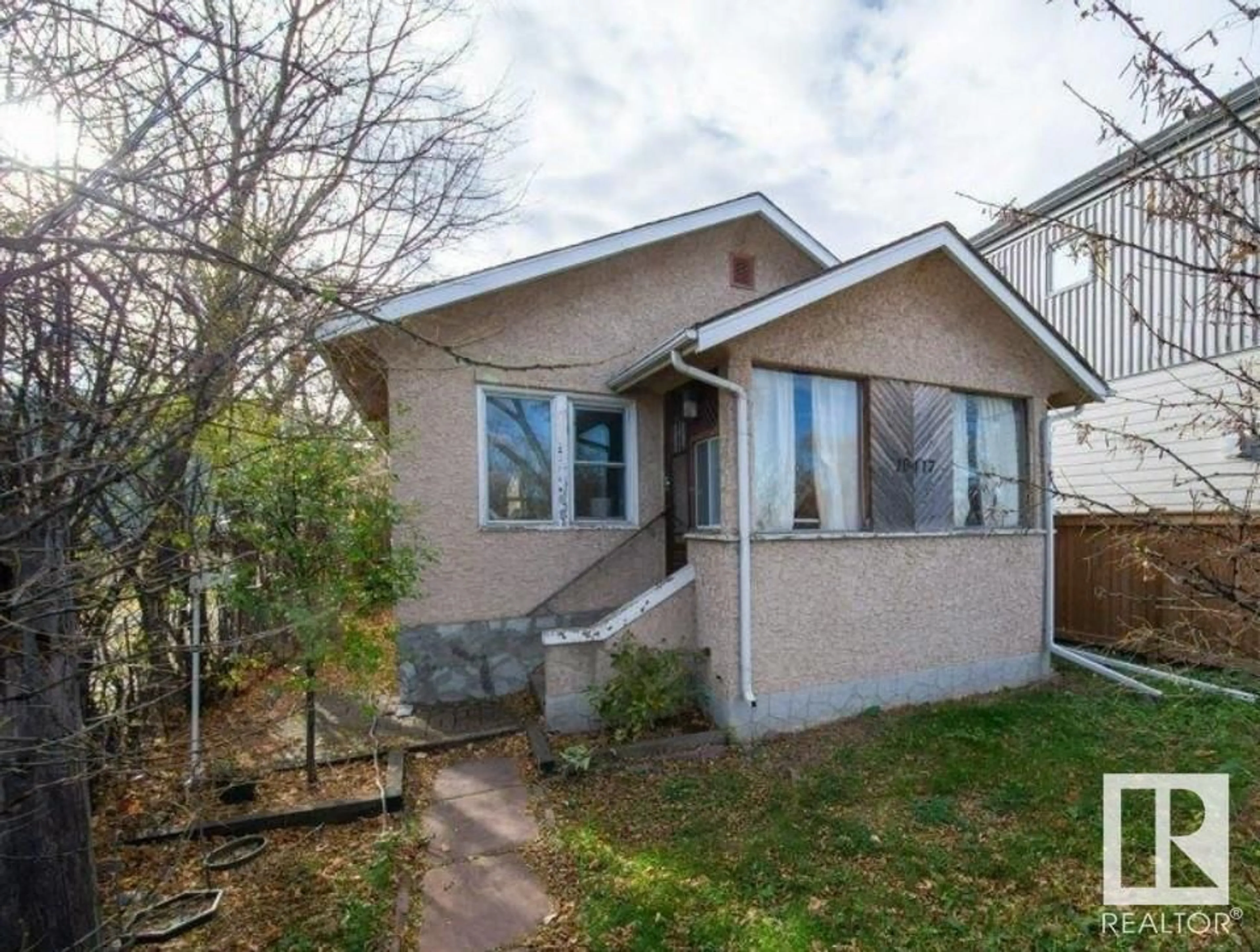 Home with vinyl exterior material, street for 10417 85 AV, Edmonton Alberta T6E2K2