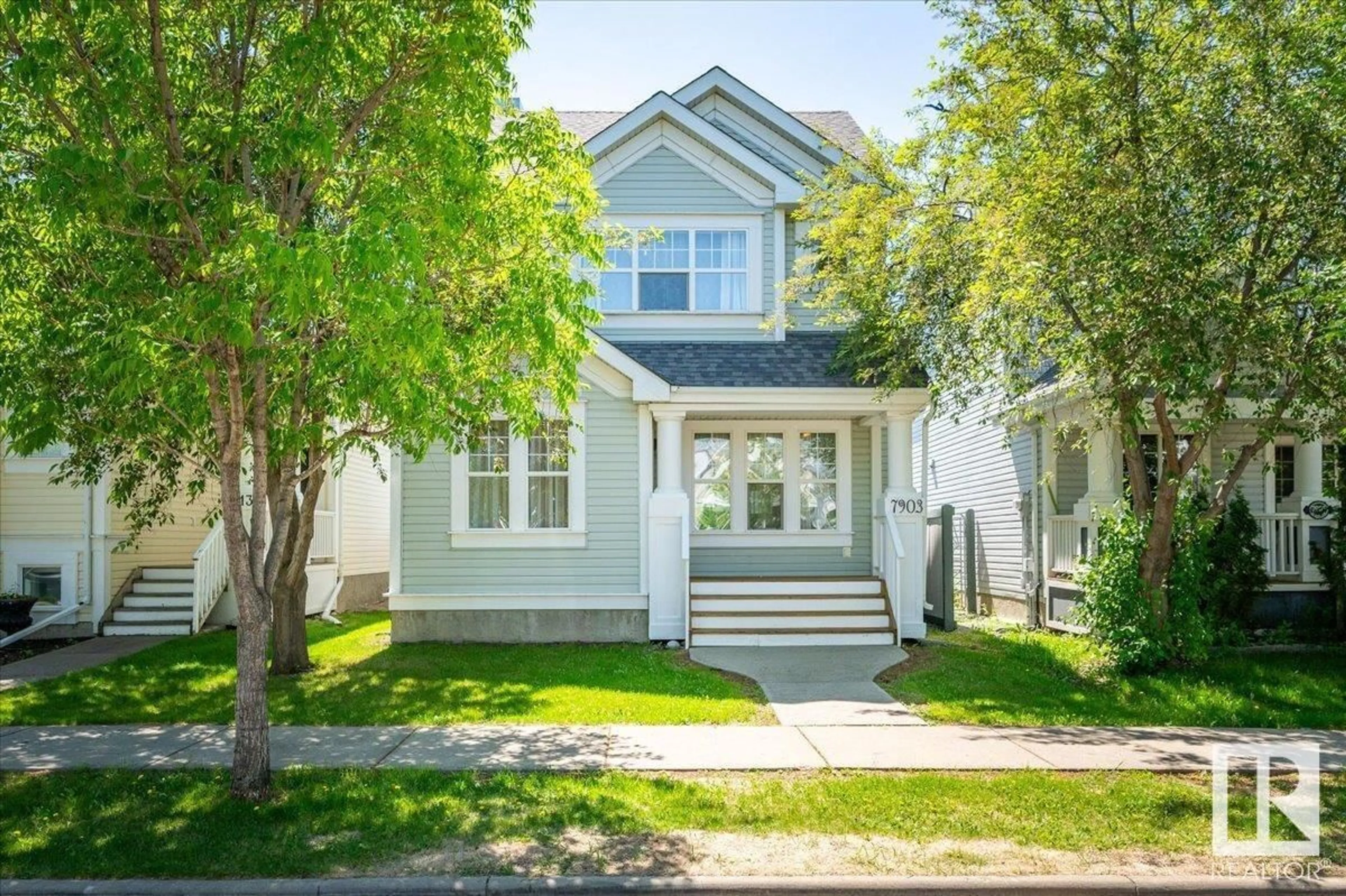 Home with vinyl exterior material, street for 7903 12 AV SW, Edmonton Alberta T6X1E6