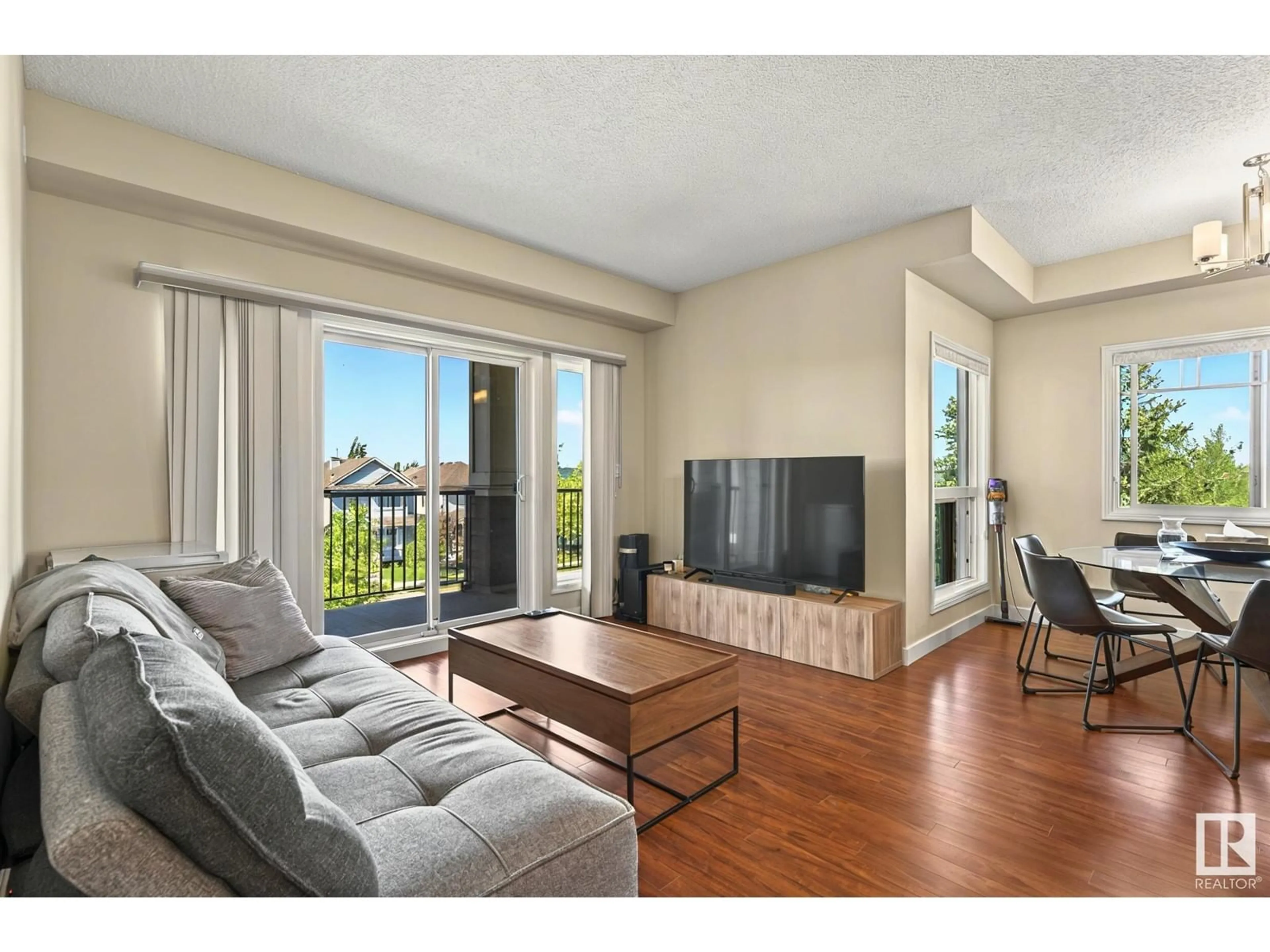 Living room with furniture, wood/laminate floor for 319 - 7021 SOUTH TERWILLEGAR DR, Edmonton Alberta T6R0W5