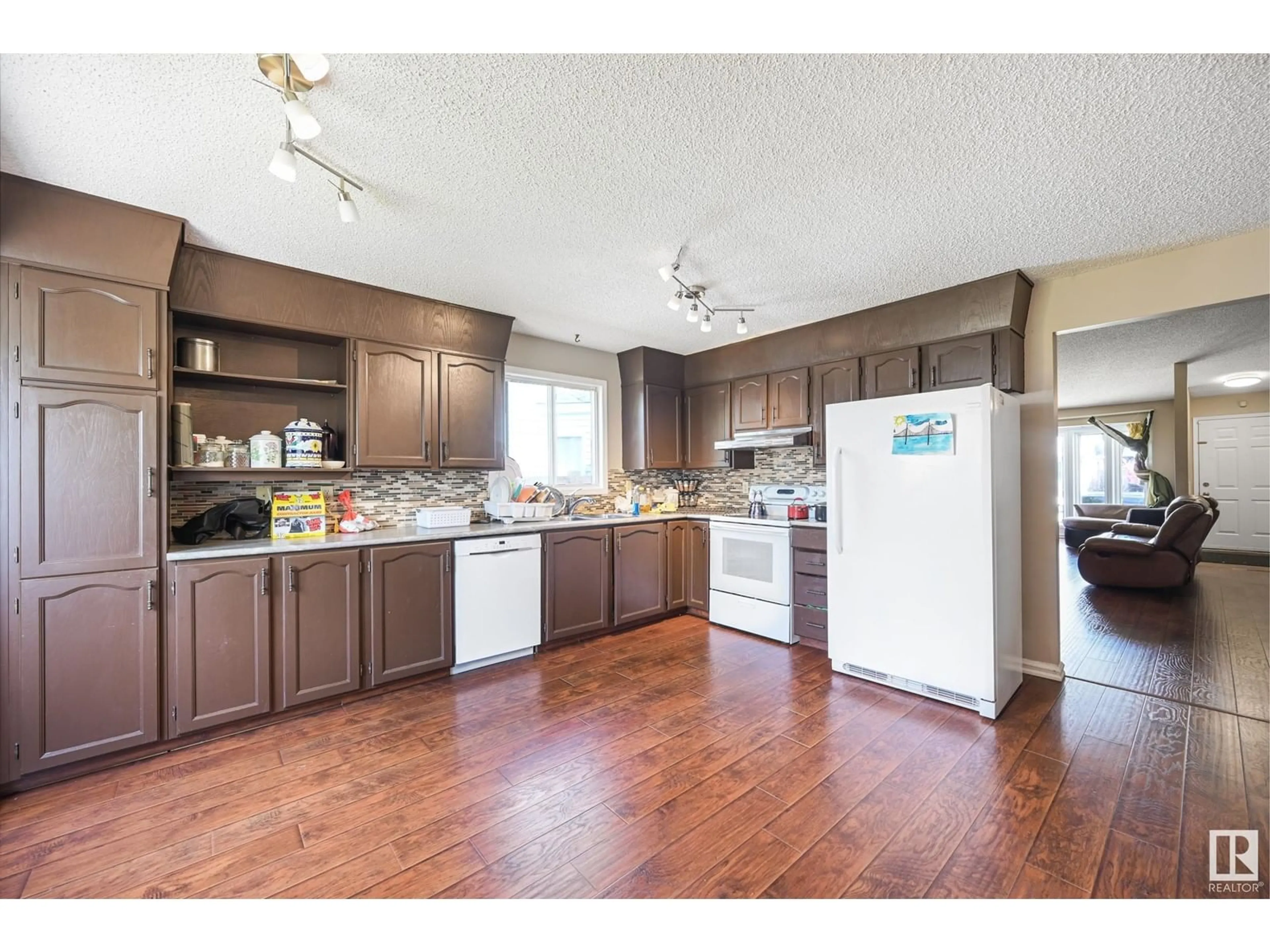 Open concept kitchen, wood/laminate floor for 17728 94 ST, Edmonton Alberta T5Z2A4