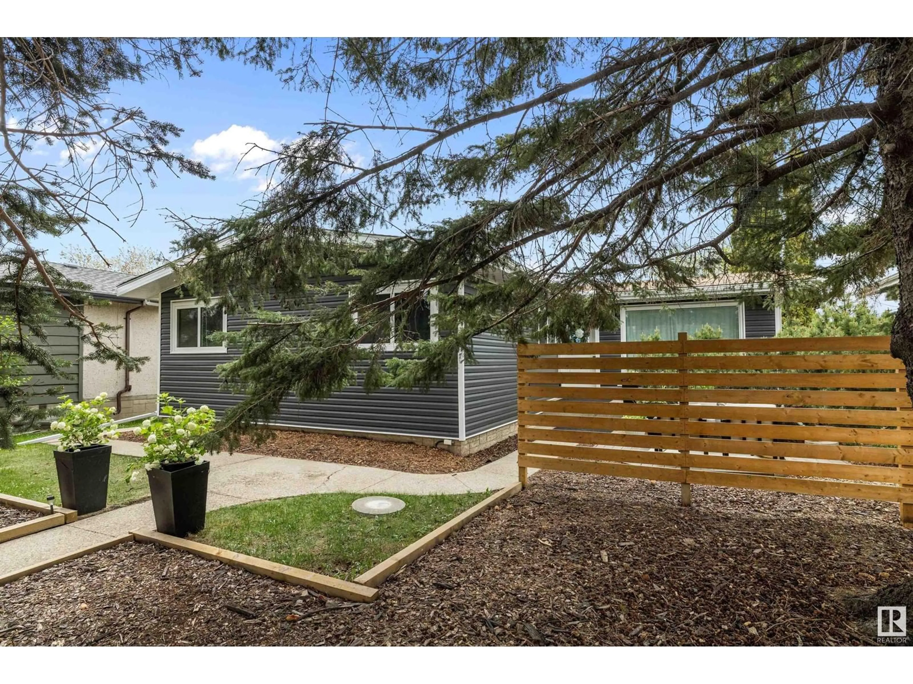 Home with vinyl exterior material, street for 6916 97 AV, Edmonton Alberta T6B1C7