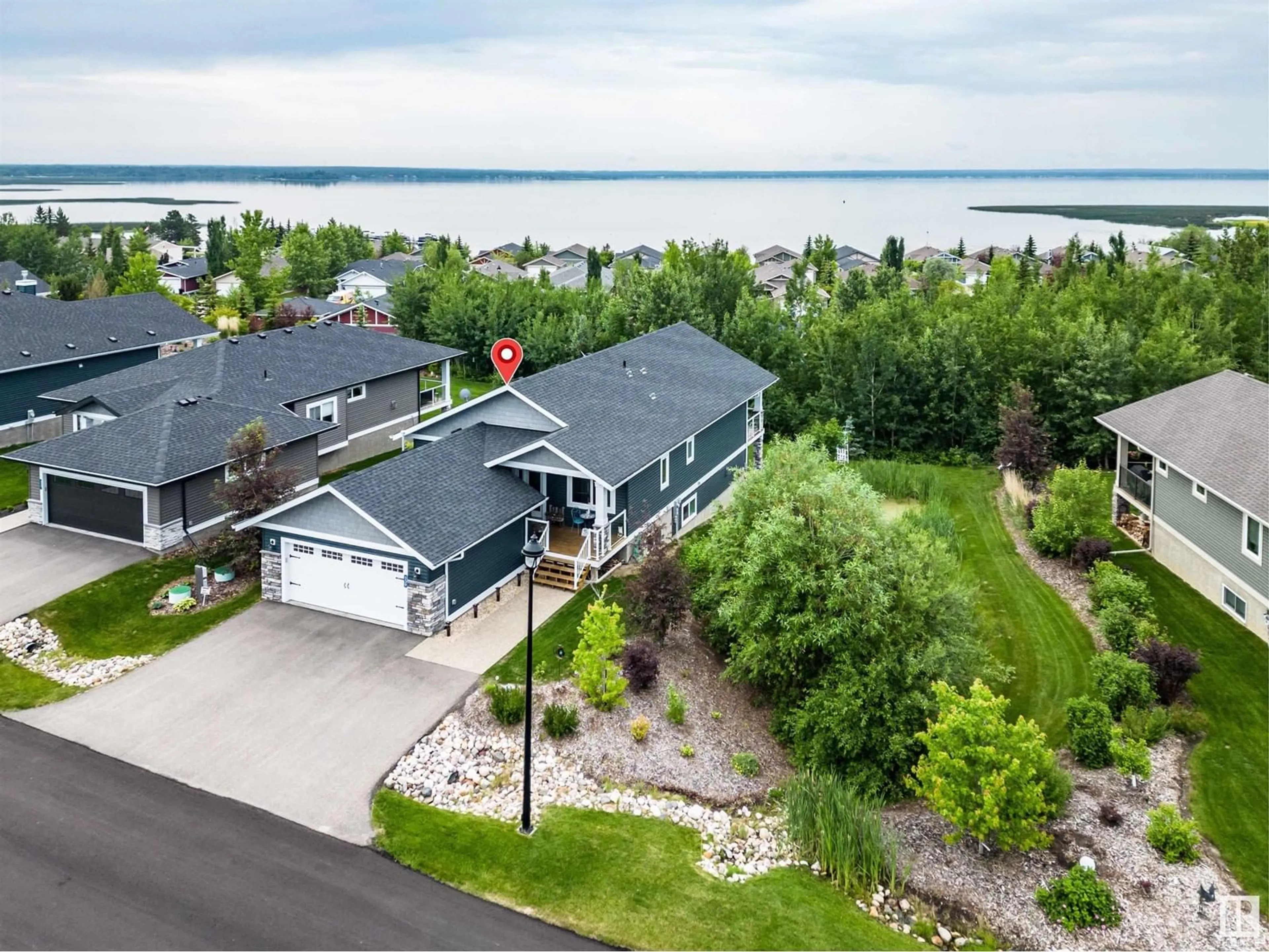 A pic from outside/outdoor area/front of a property/back of a property/a pic from drone, water/lake/river/ocean view for 55101 - 539 STE. ANNE TR, Rural Lac Ste. Anne County Alberta T0E1A1