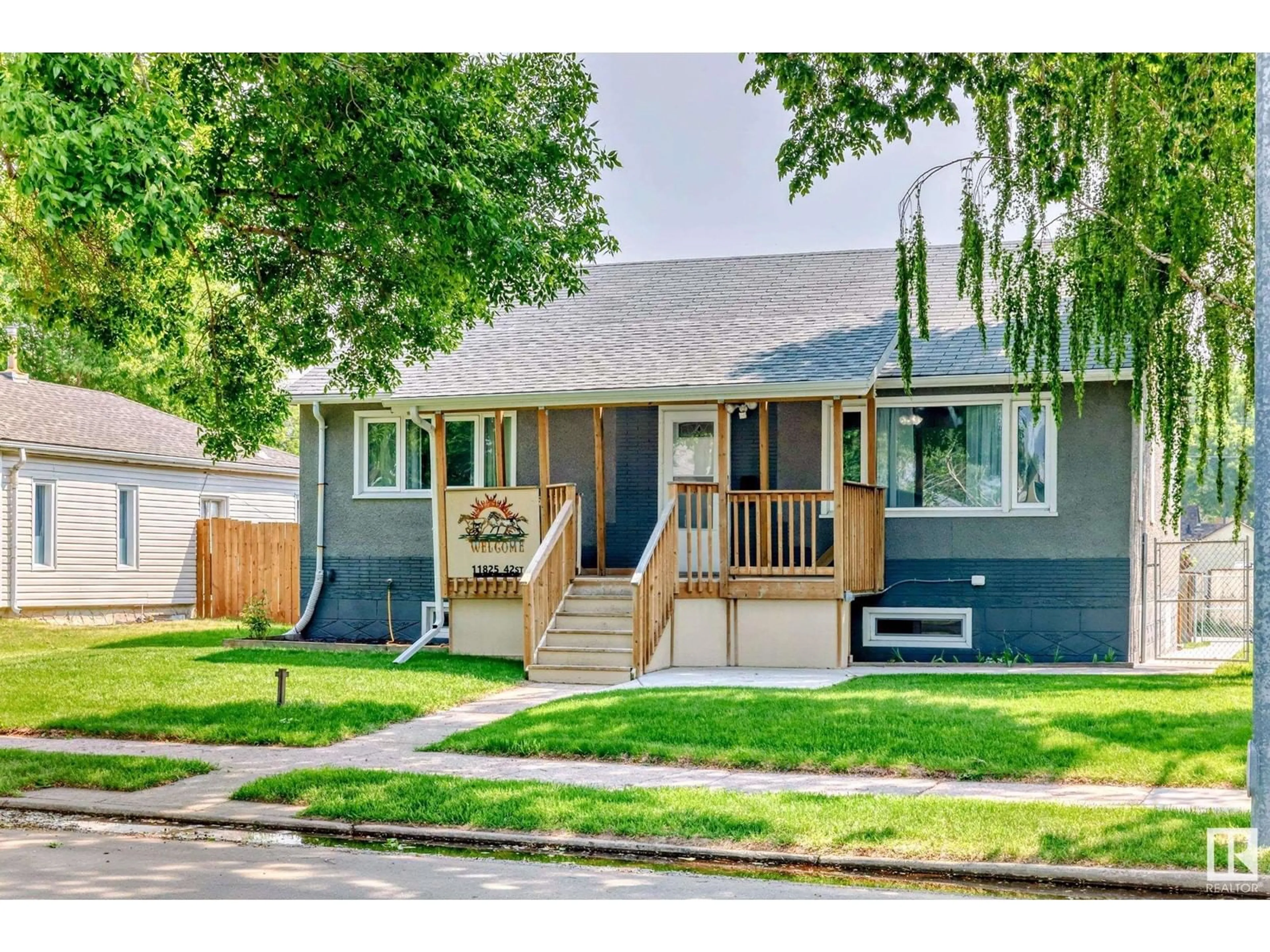 Home with vinyl exterior material, street for 11825 42 ST, Edmonton Alberta T5W2N3