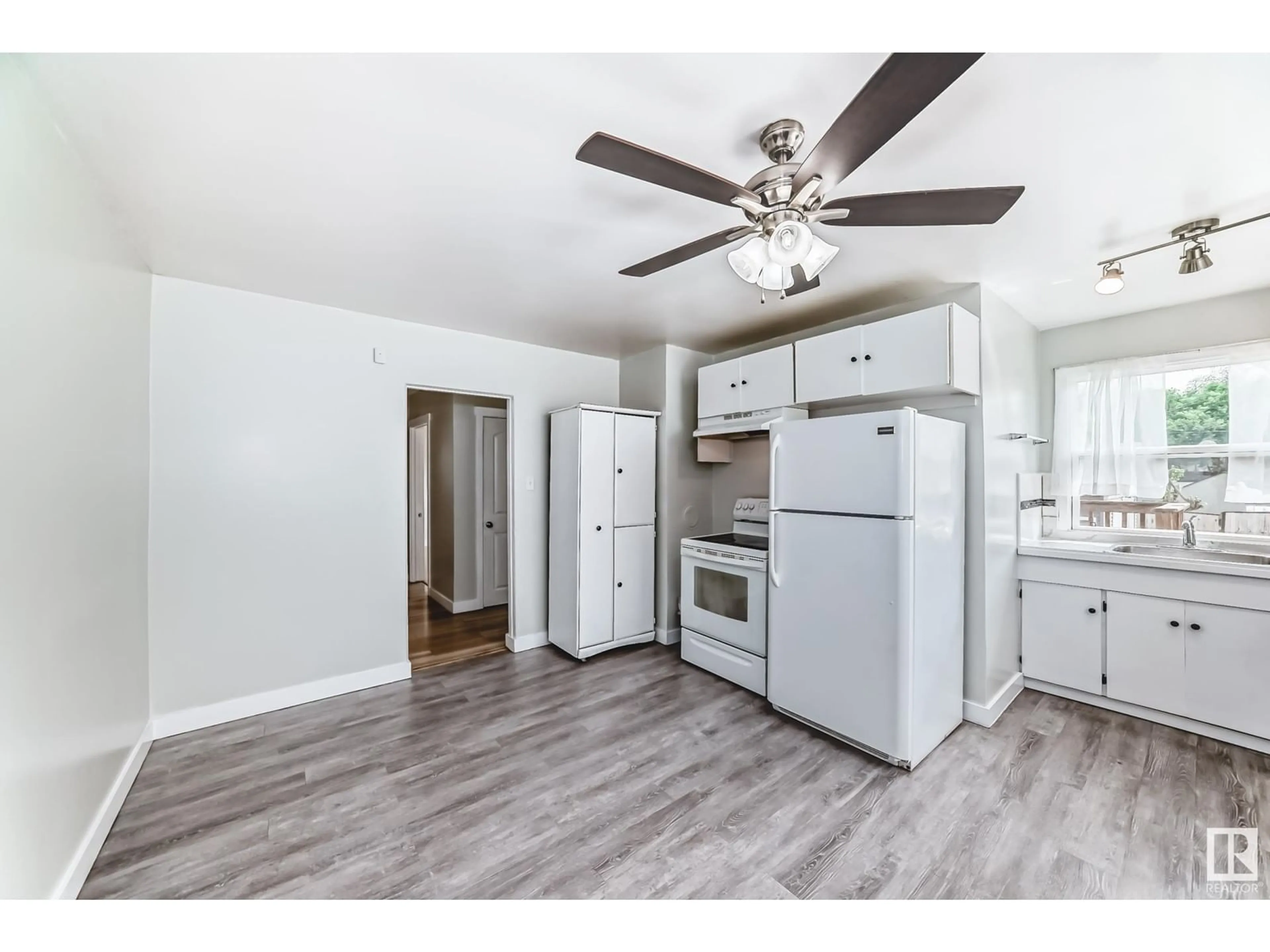 Open concept kitchen, wood/laminate floor for 11825 42 ST, Edmonton Alberta T5W2N3