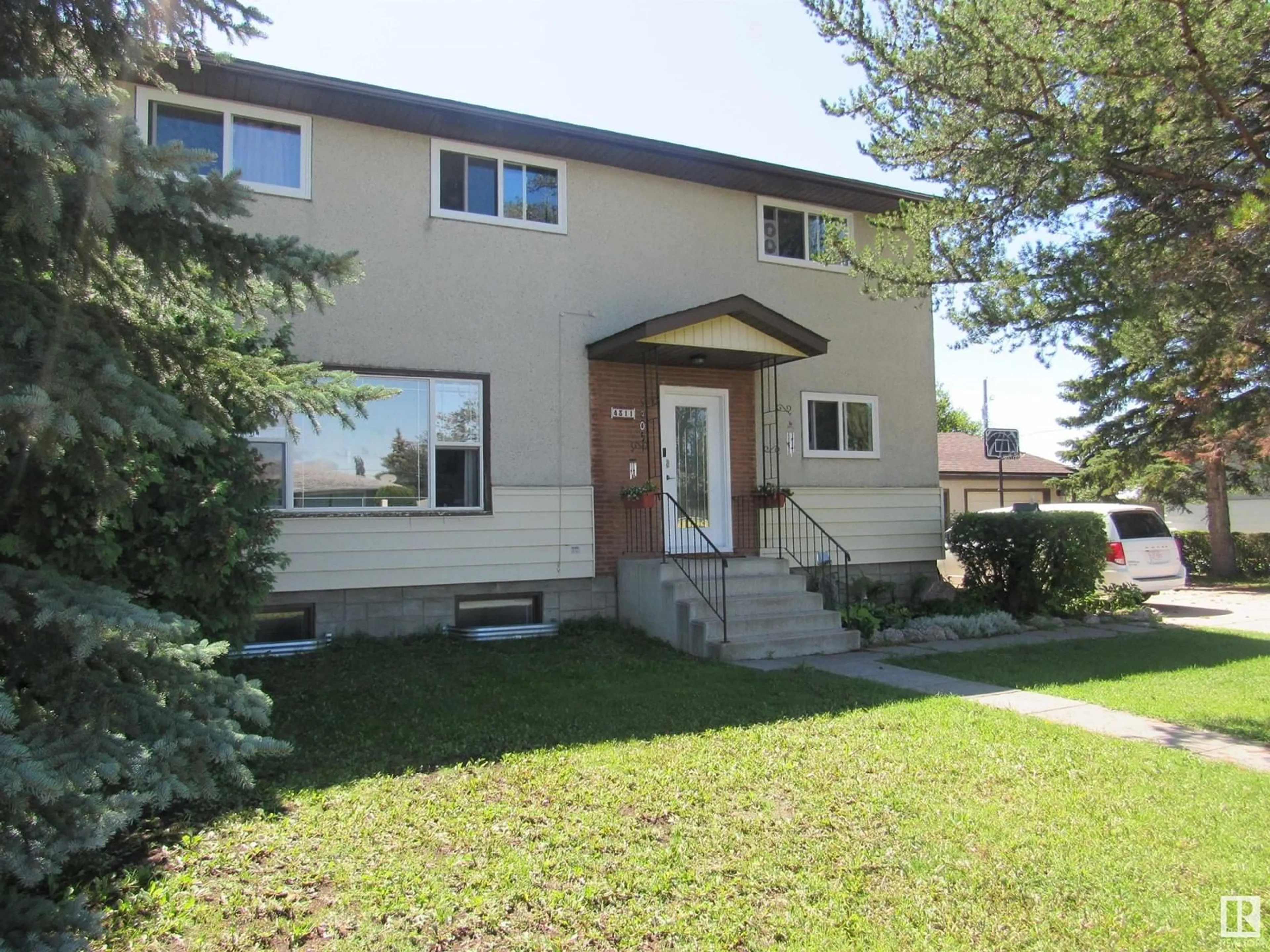 Home with vinyl exterior material, street for 4311 57 AV, Barrhead Alberta T7N1K3