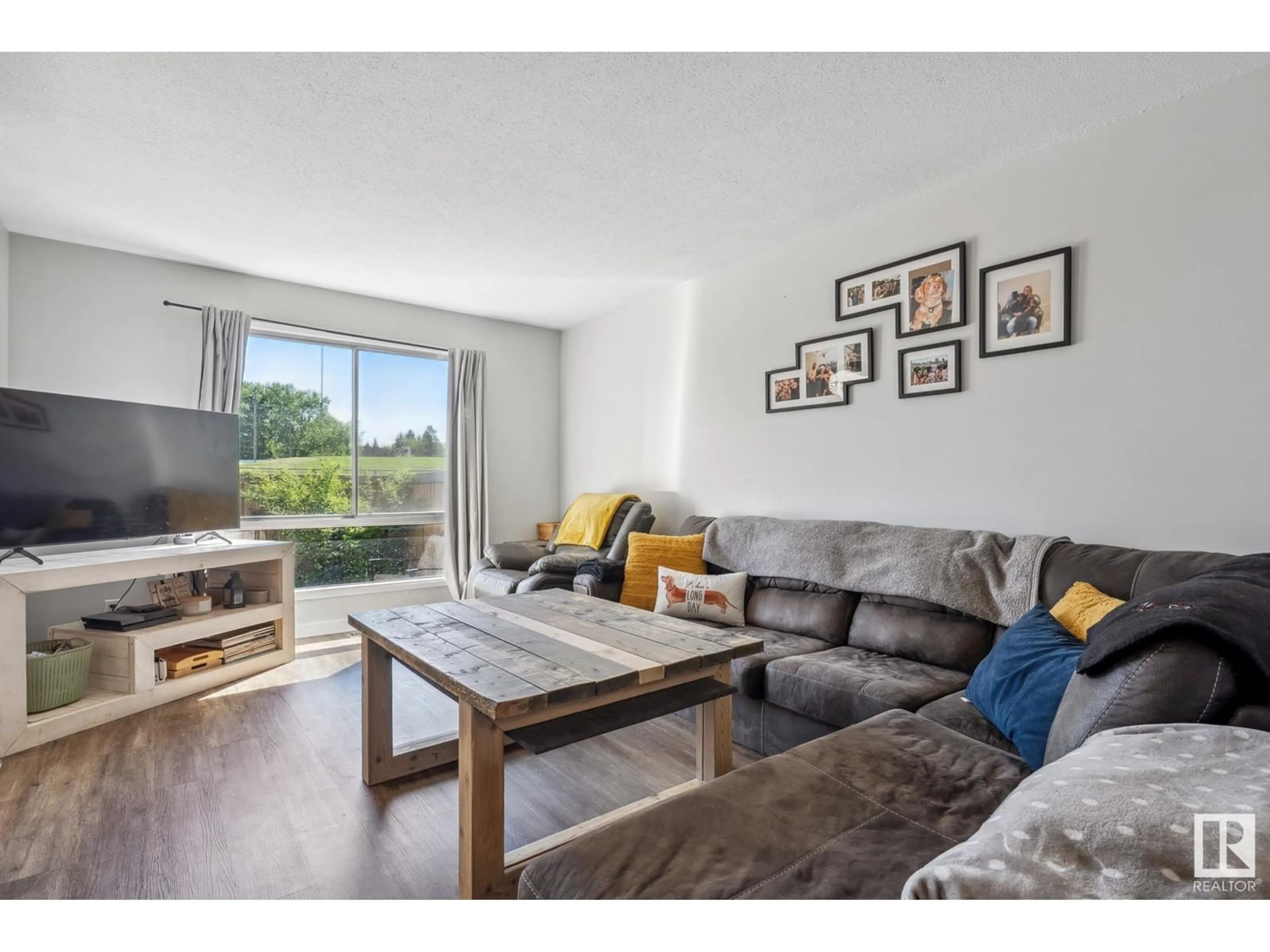 Living room with furniture, wood/laminate floor for 97 GRANDIN VG, St. Albert Alberta T8N1R9