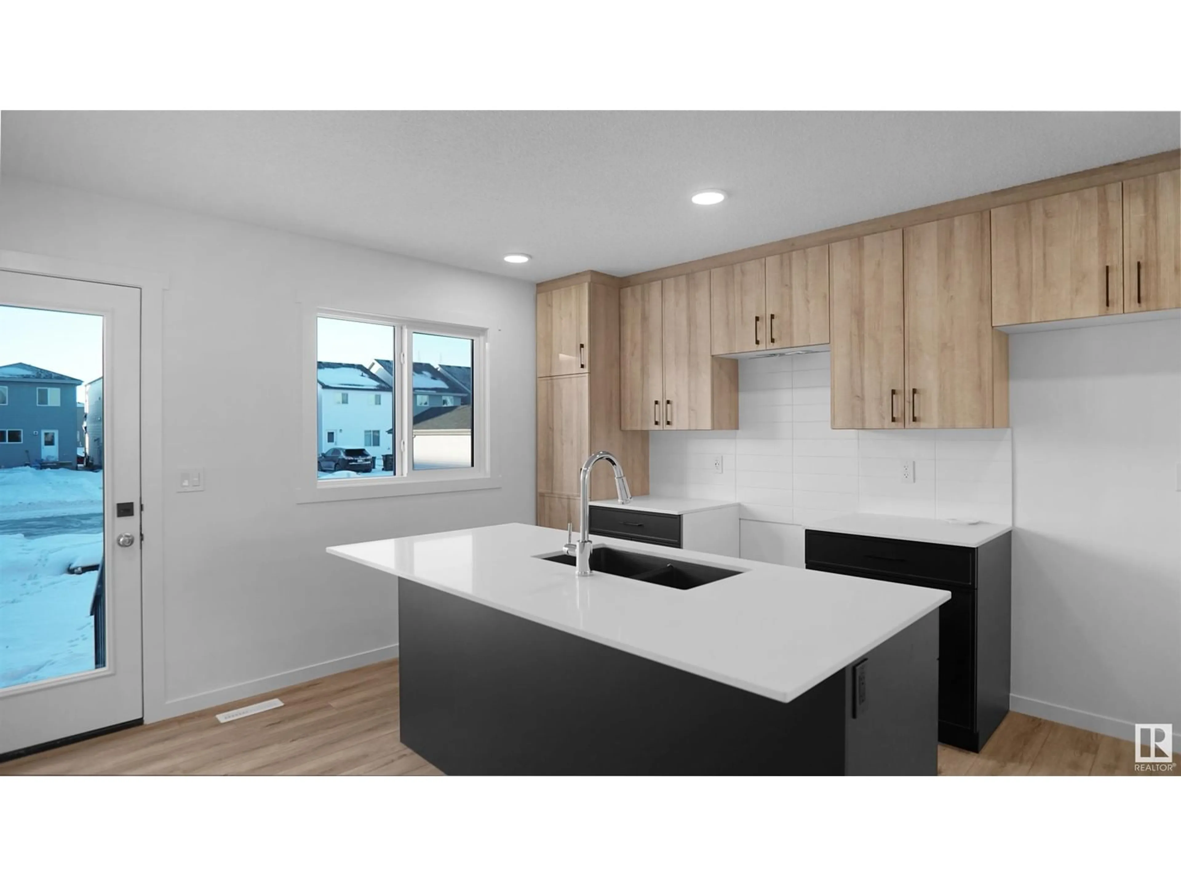 Open concept kitchen, wood/laminate floor for #32 - 525 SECORD BV, Edmonton Alberta T5T4A4