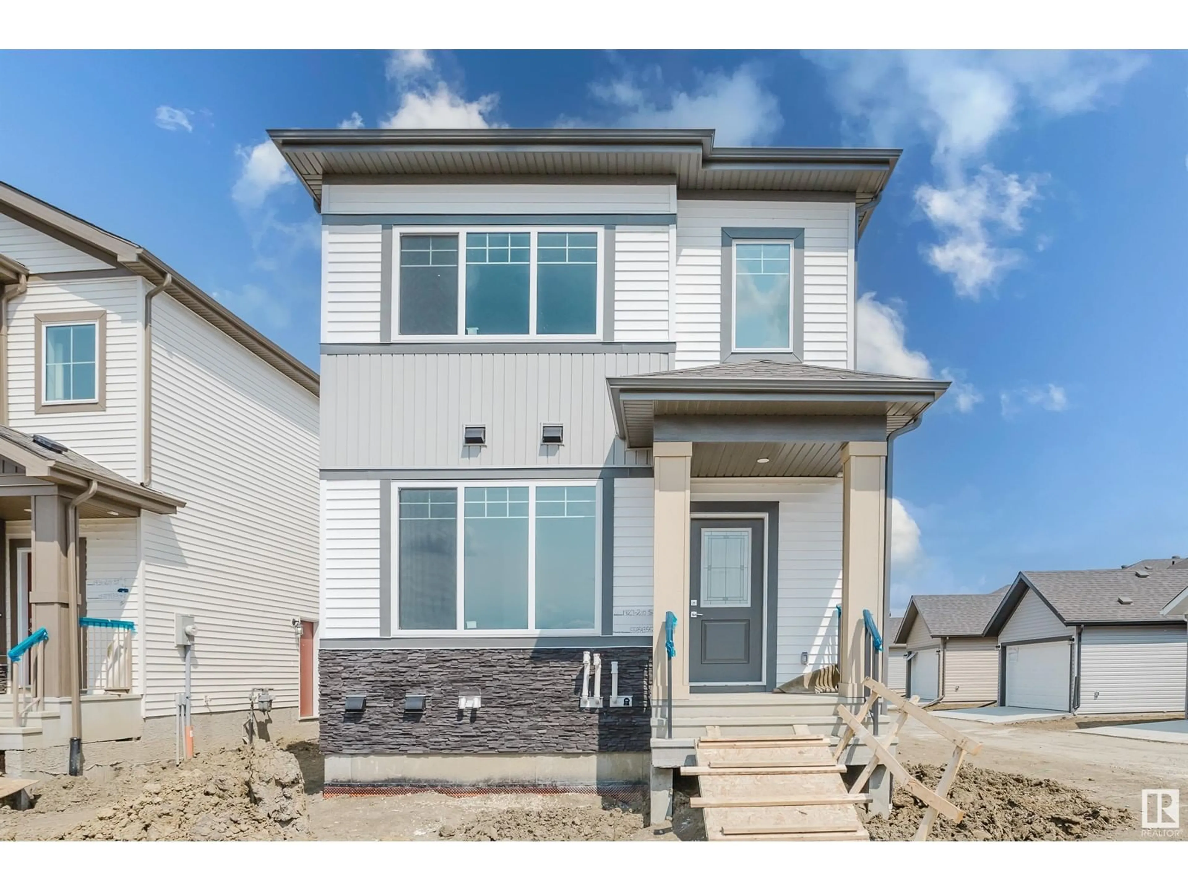 Home with vinyl exterior material, street for 1927 210 ST, Edmonton Alberta T6M3H5