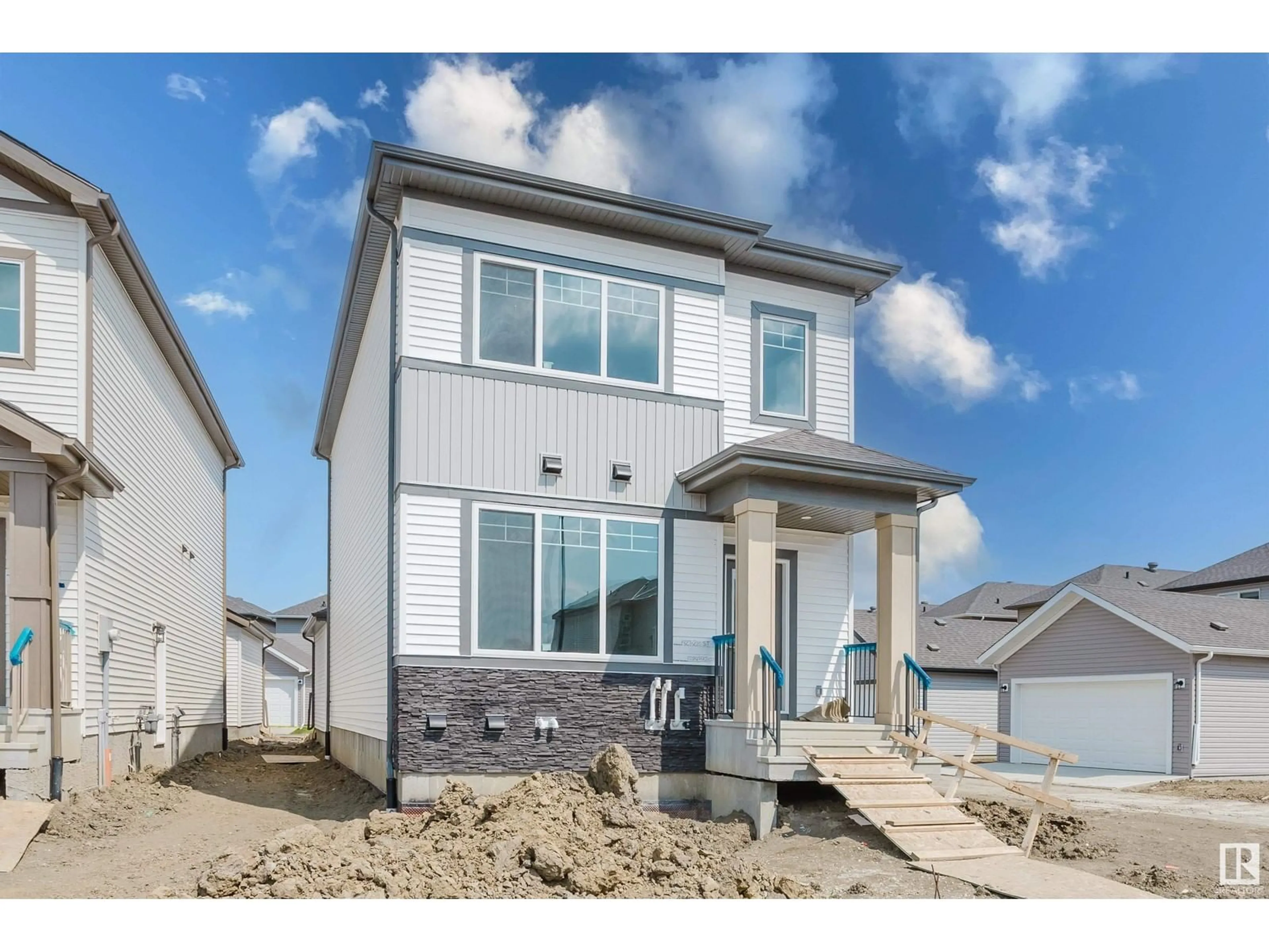 Home with vinyl exterior material, street for 1927 210 ST, Edmonton Alberta T6M3H5