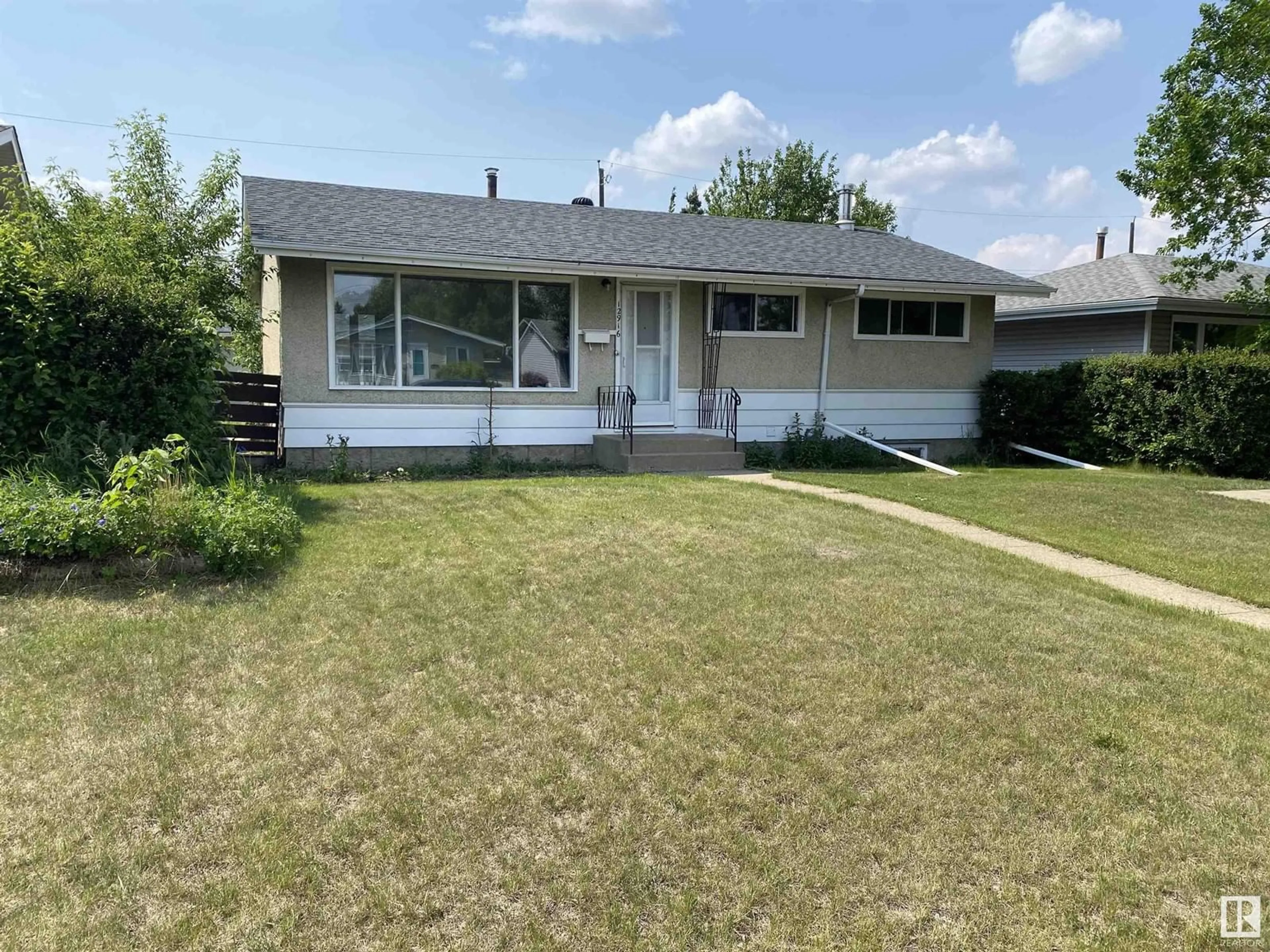 Home with vinyl exterior material, street for NW - 12916 135 ST, Edmonton Alberta T5L1Y2