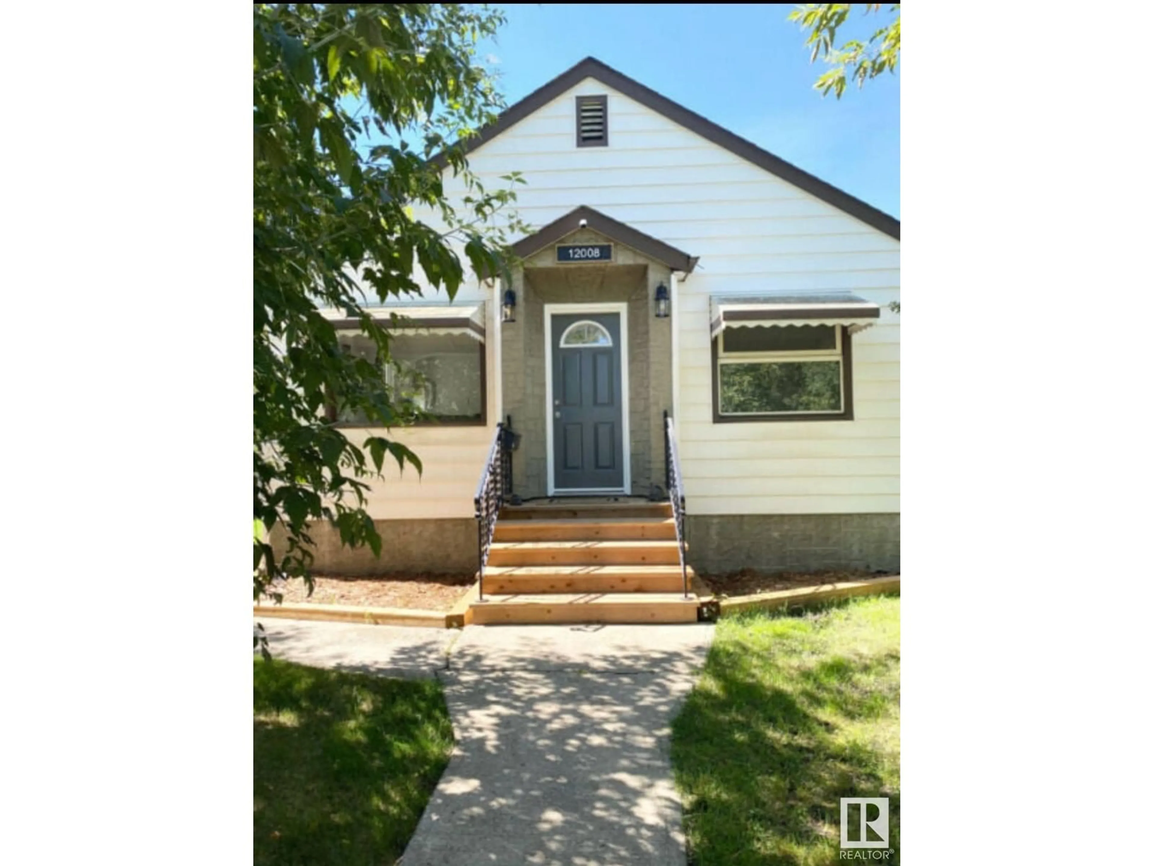 Home with vinyl exterior material, street for 12008 64 ST, Edmonton Alberta T5W4J6