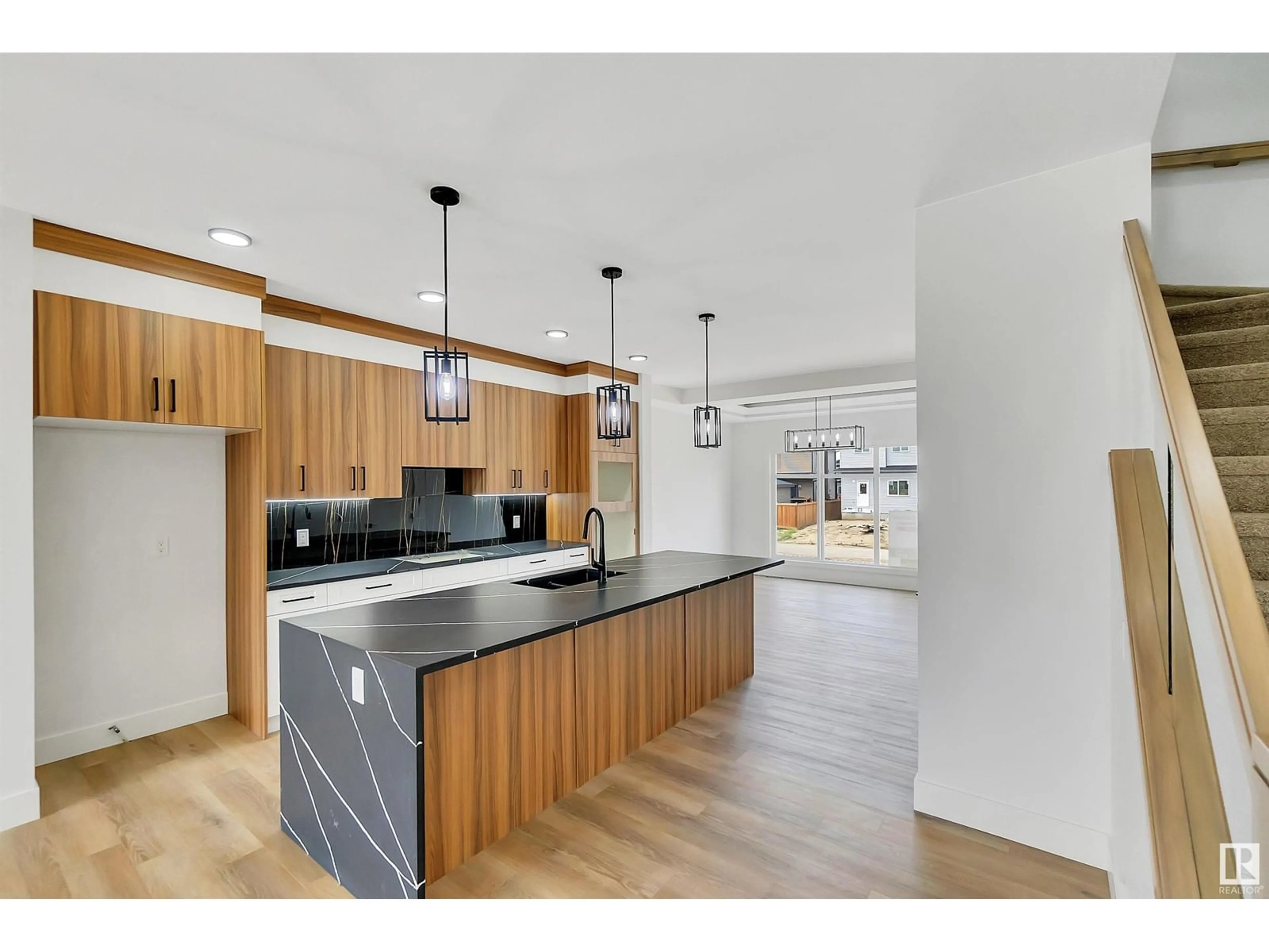 Open concept kitchen, wood/laminate floor for 4383 37 ST, Beaumont Alberta T4X3A7