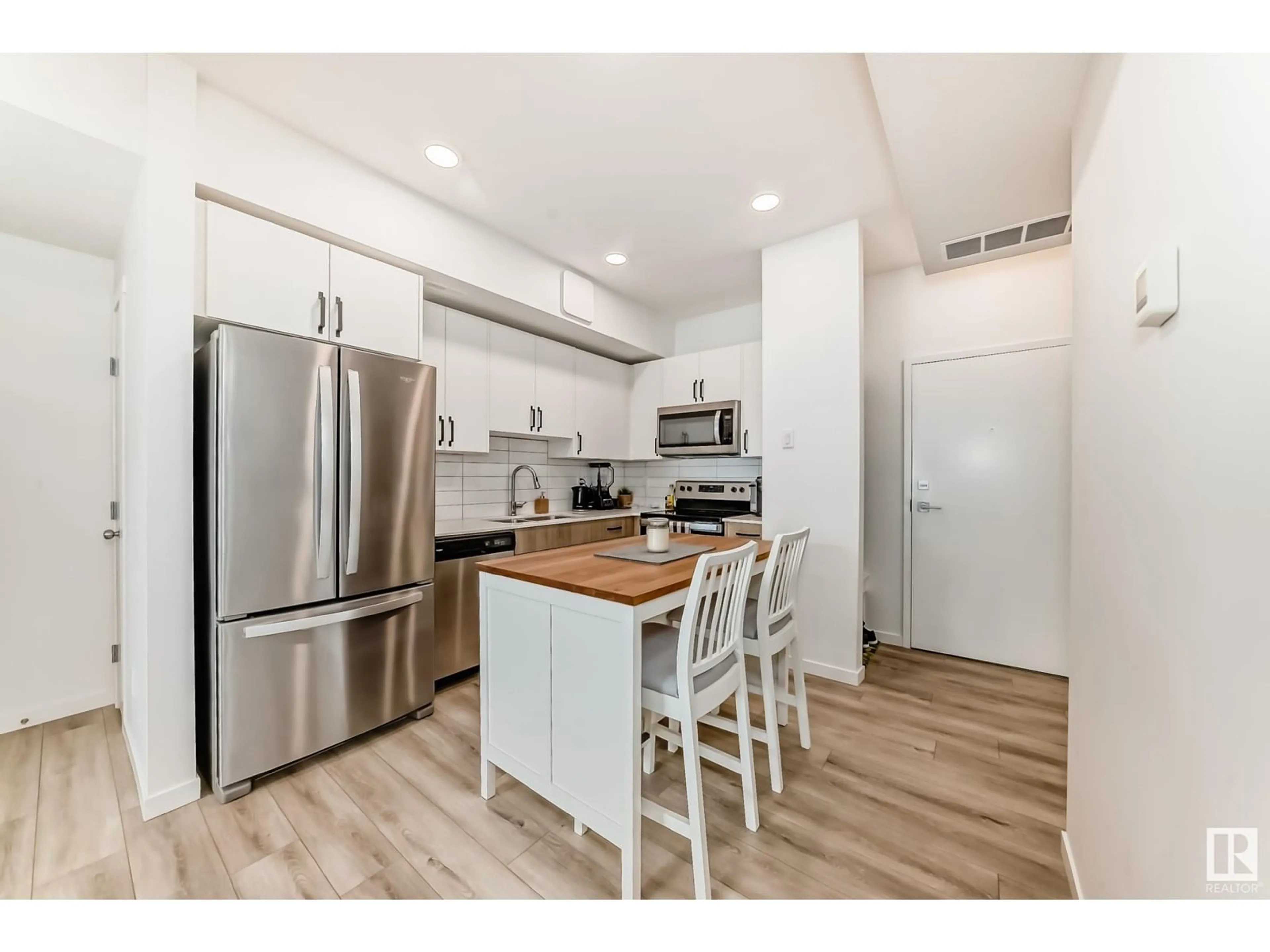 Open concept kitchen, wood/laminate floor for #306 - 860 SECORD BV, Edmonton Alberta T5T7R9