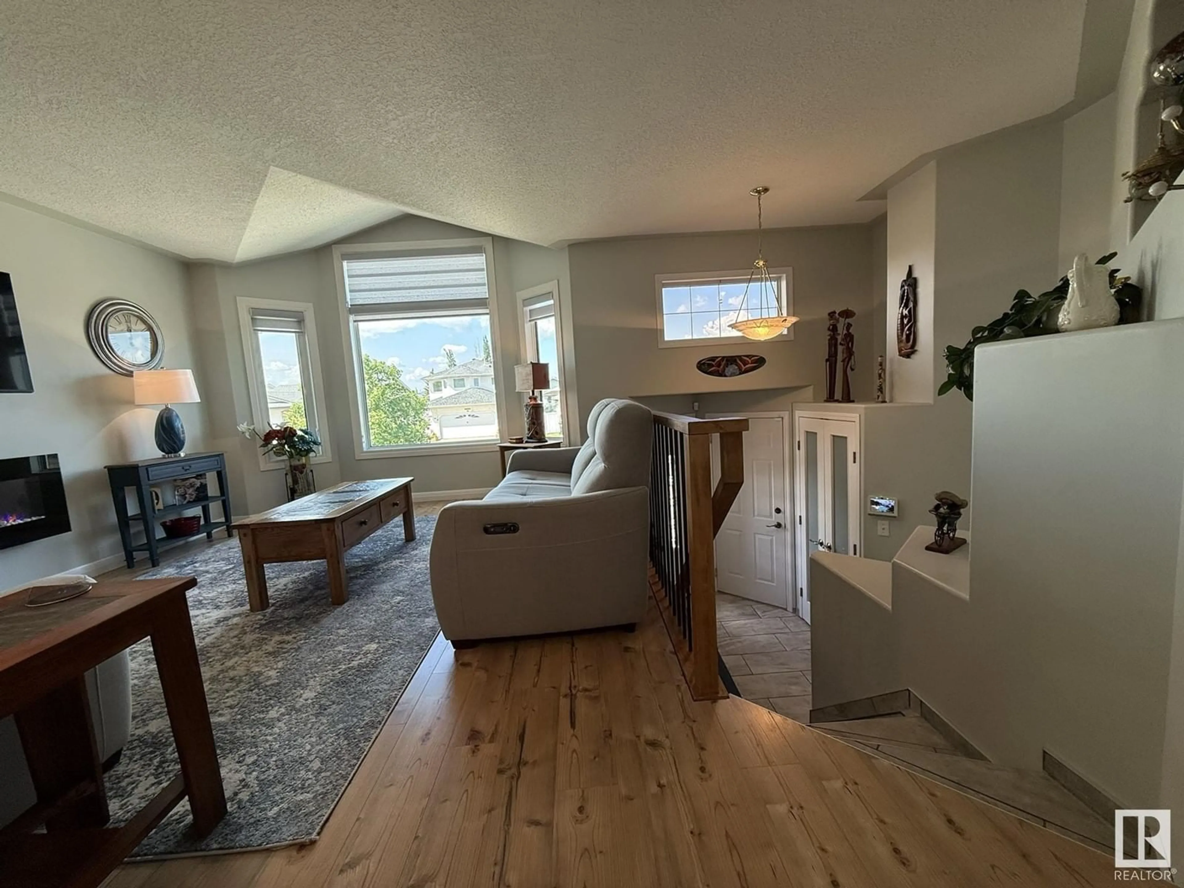 Living room with furniture, wood/laminate floor for NW - 16103 67 ST, Edmonton Alberta T5Z3C5