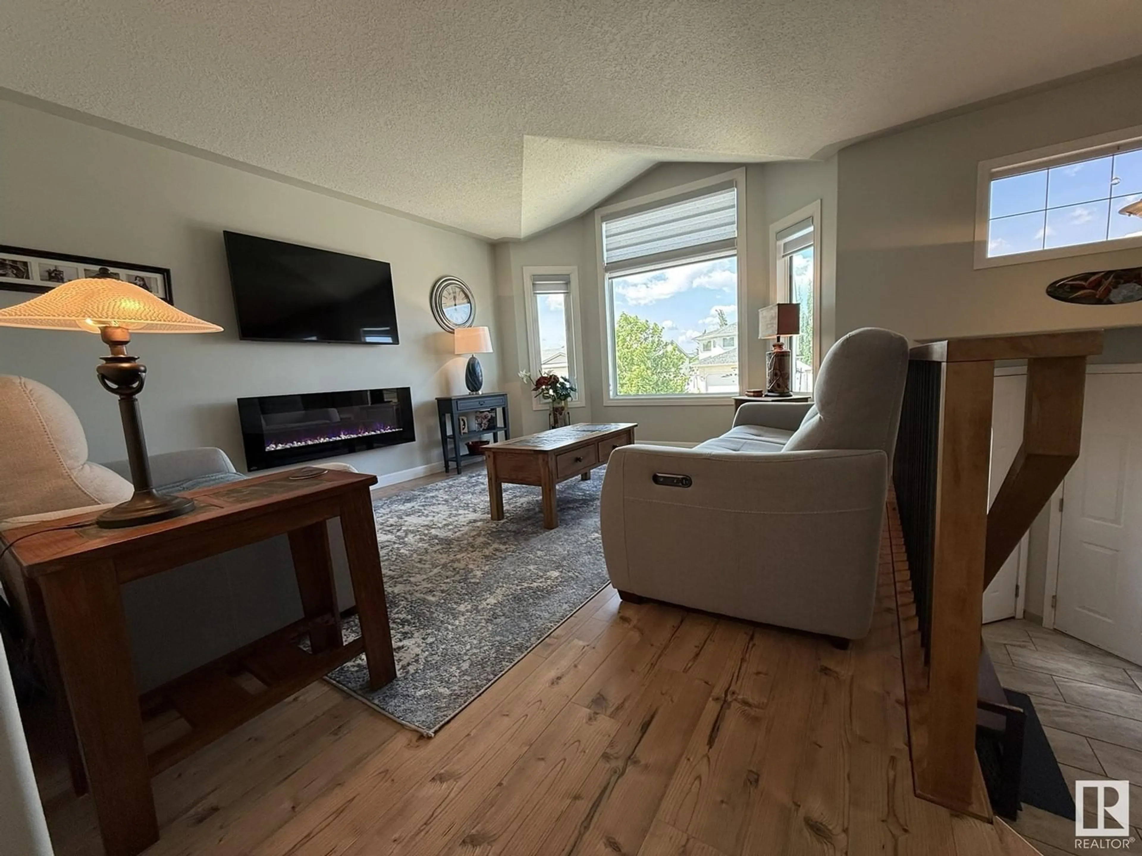 Living room with furniture, wood/laminate floor for NW - 16103 67 ST, Edmonton Alberta T5Z3C5